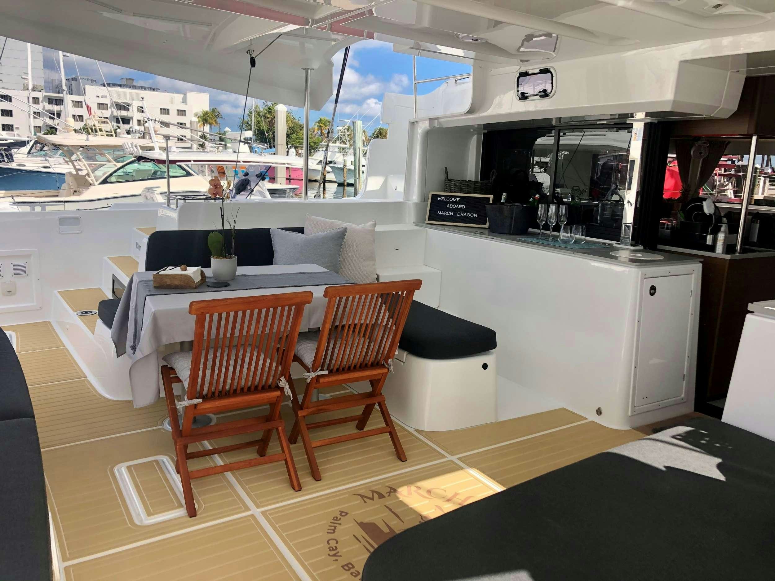 a room with a table chairs and a couch aboard MARCH DRAGON Yacht for Charter