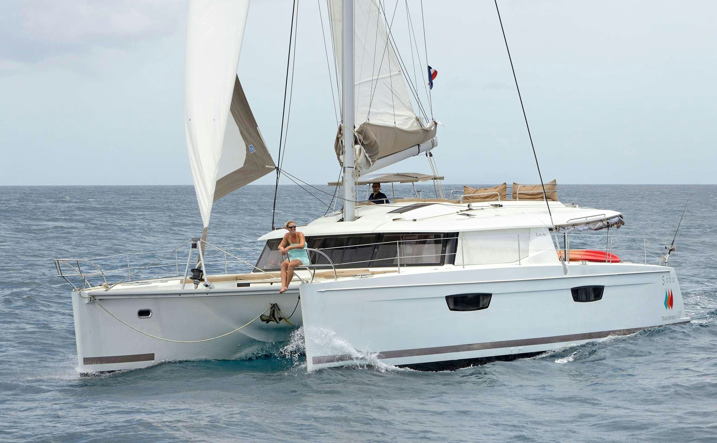 a couple of people on a sailboat aboard Cruising TW52 Yacht for Charter