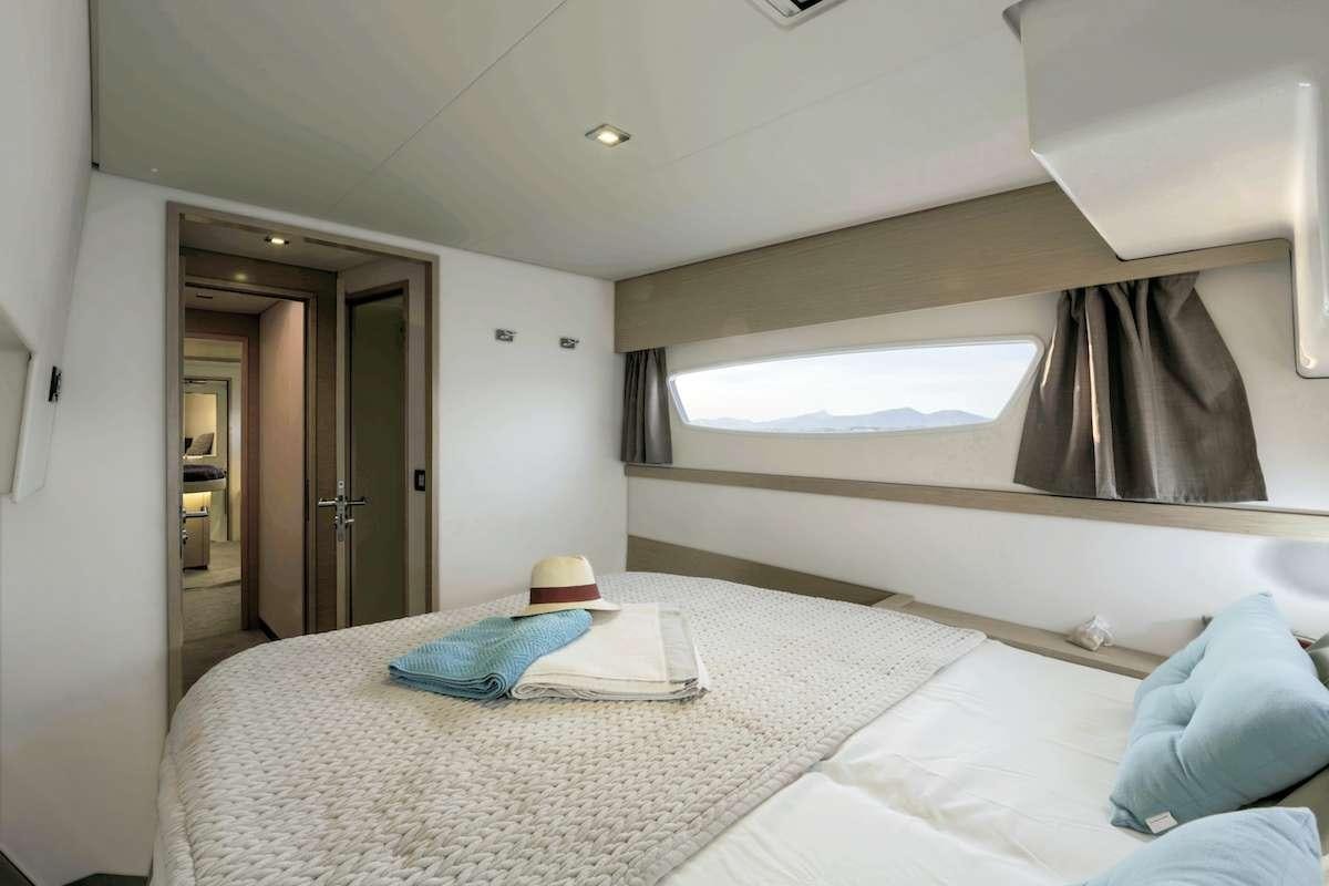 a bed with a white sheet on it aboard Cruising TW52 Yacht for Charter