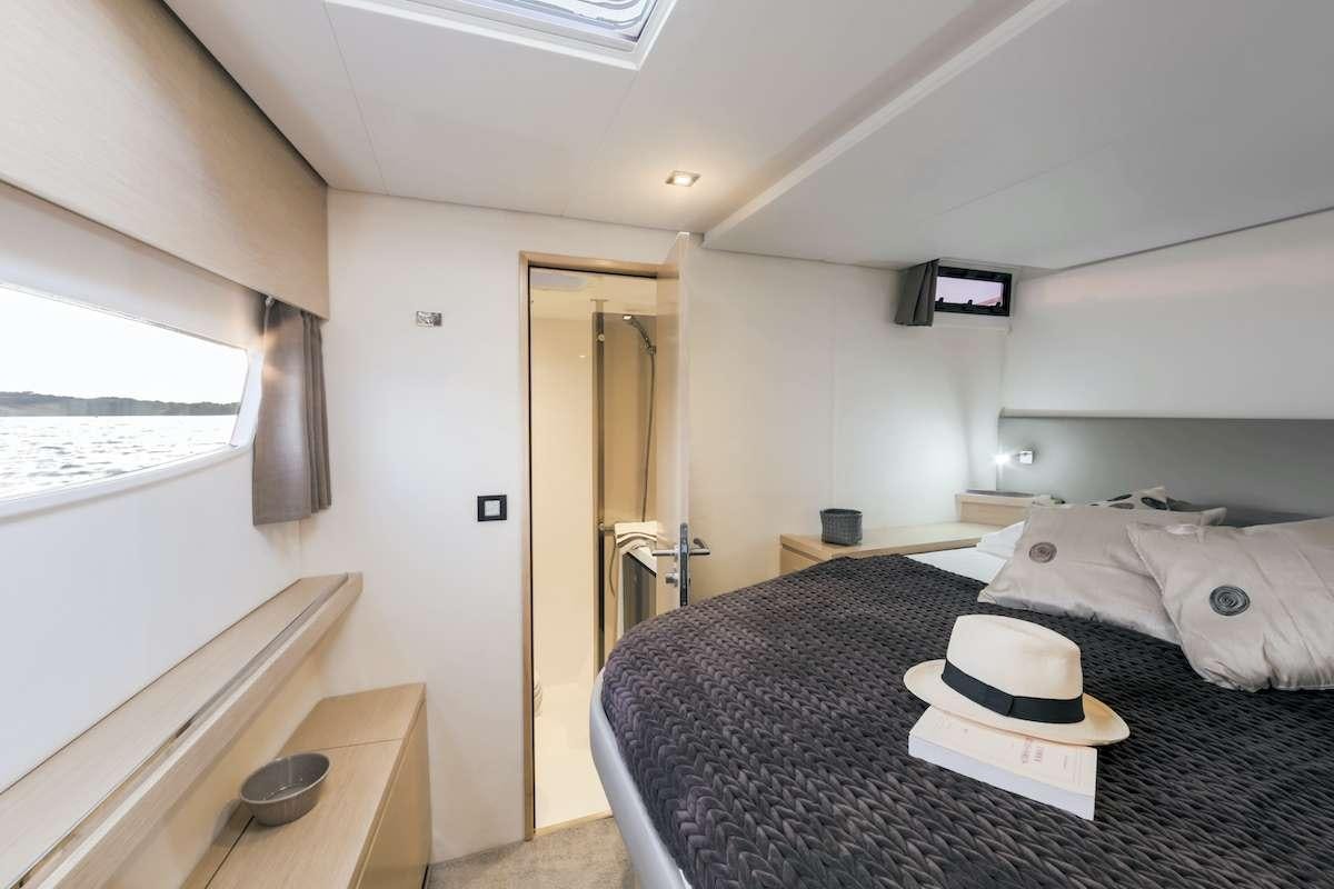 a bedroom with a bed and a desk aboard Cruising TW52 Yacht for Charter
