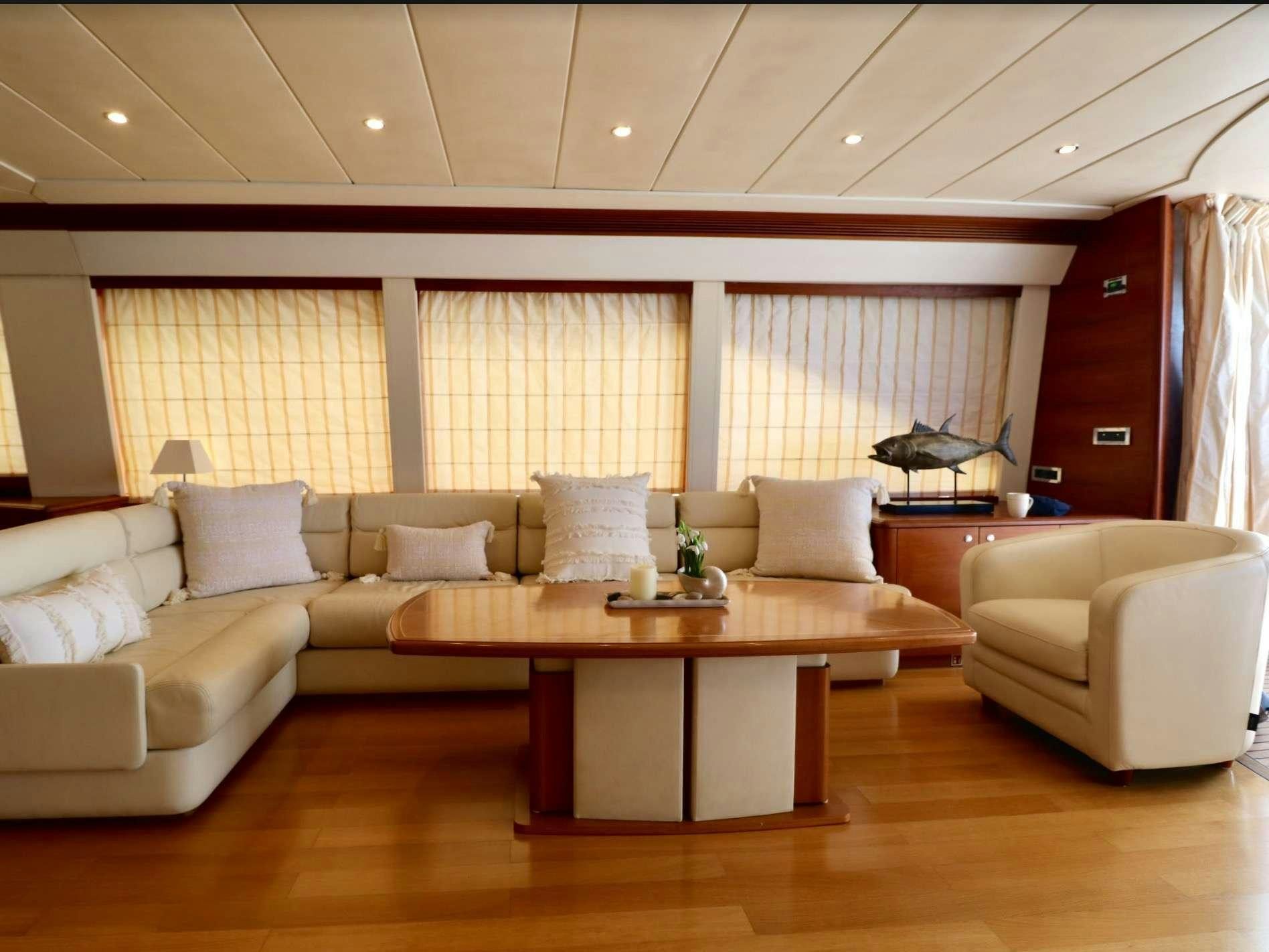 a living room with a table and couches aboard ECLIPSE 114 Yacht for Charter