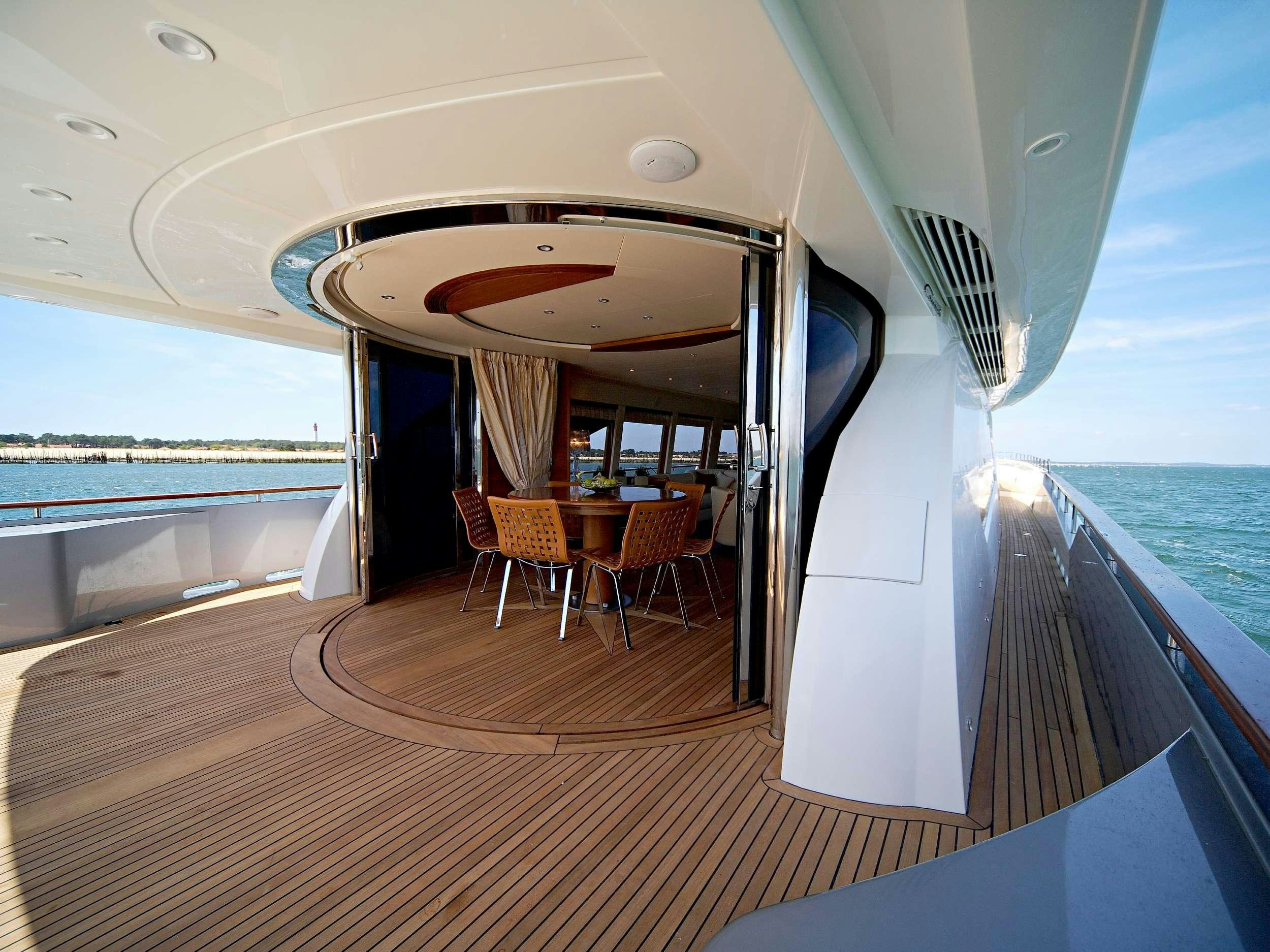 a boat with a table and chairs on a deck aboard ECLIPSE 114 Yacht for Charter