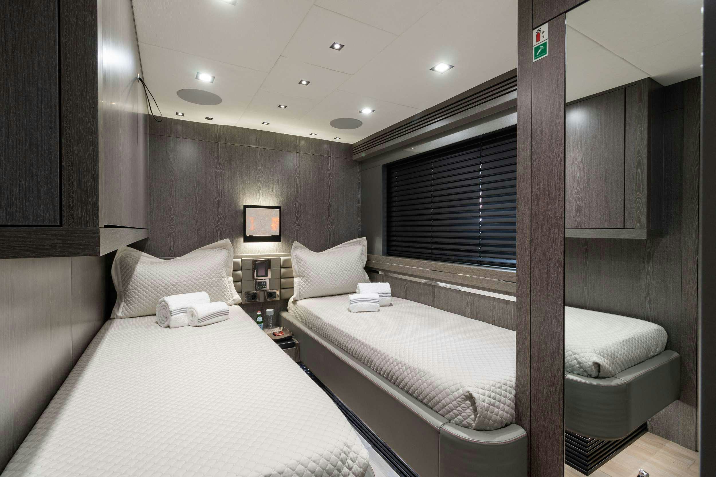 a couple of beds in a hotel room aboard CANELO Yacht for Charter