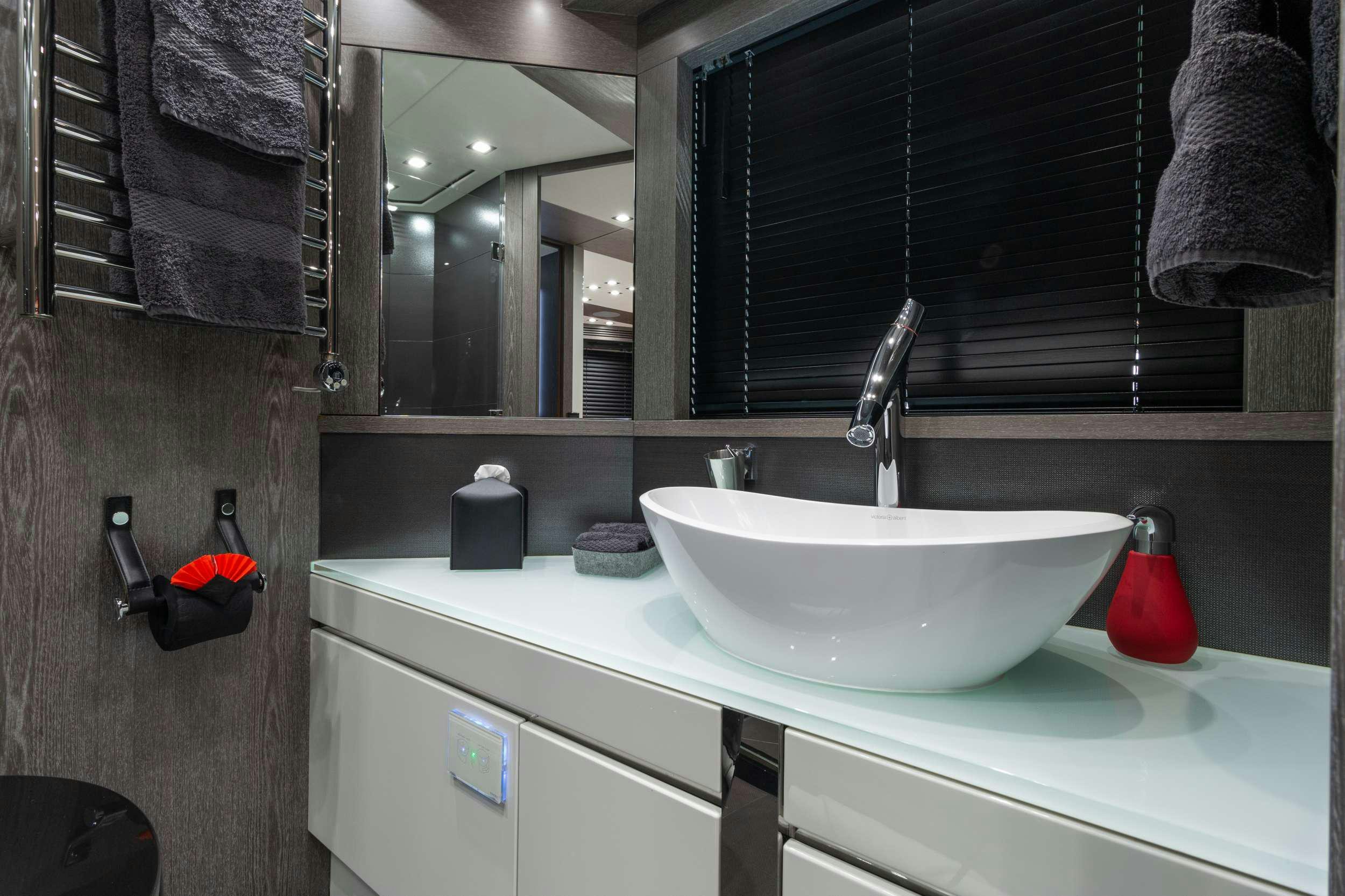 a bathroom with a sink and mirror aboard CANELO Yacht for Charter