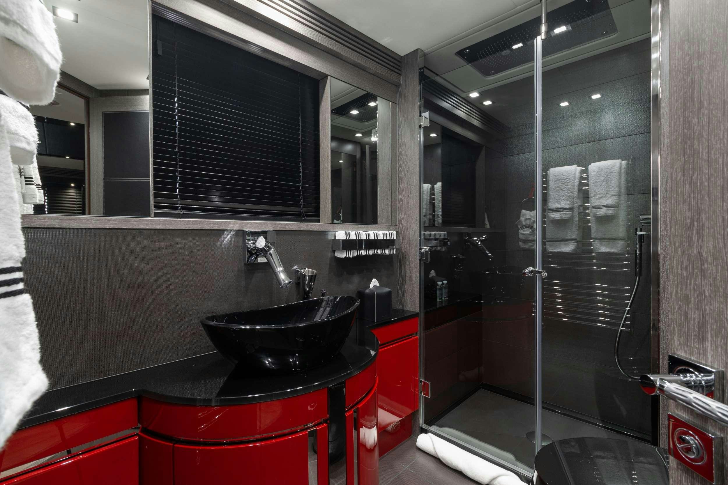 a kitchen with a sink and a large mirror aboard CANELO Yacht for Charter