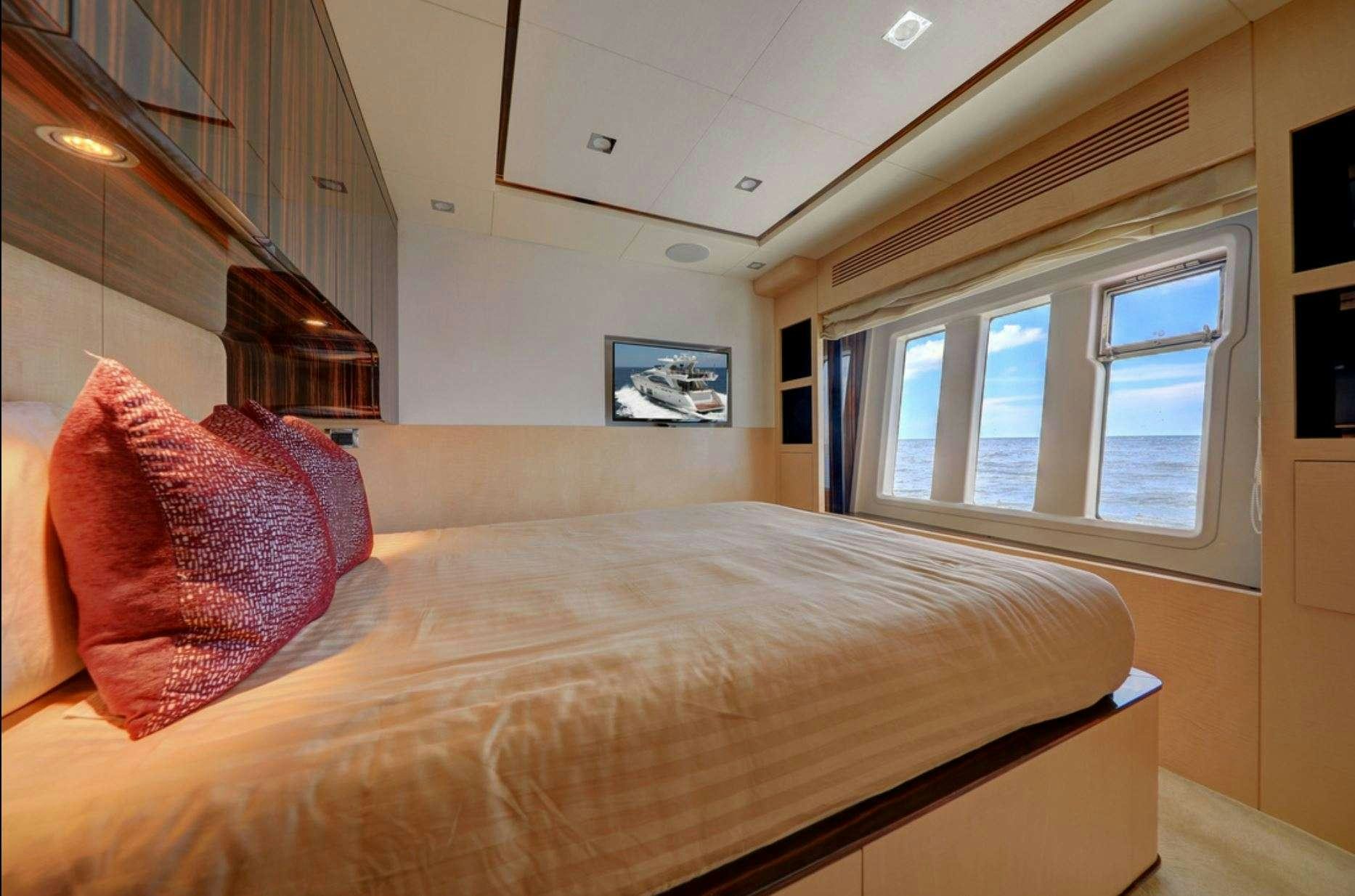 a bed with a brown comforter aboard VALERE Yacht for Charter
