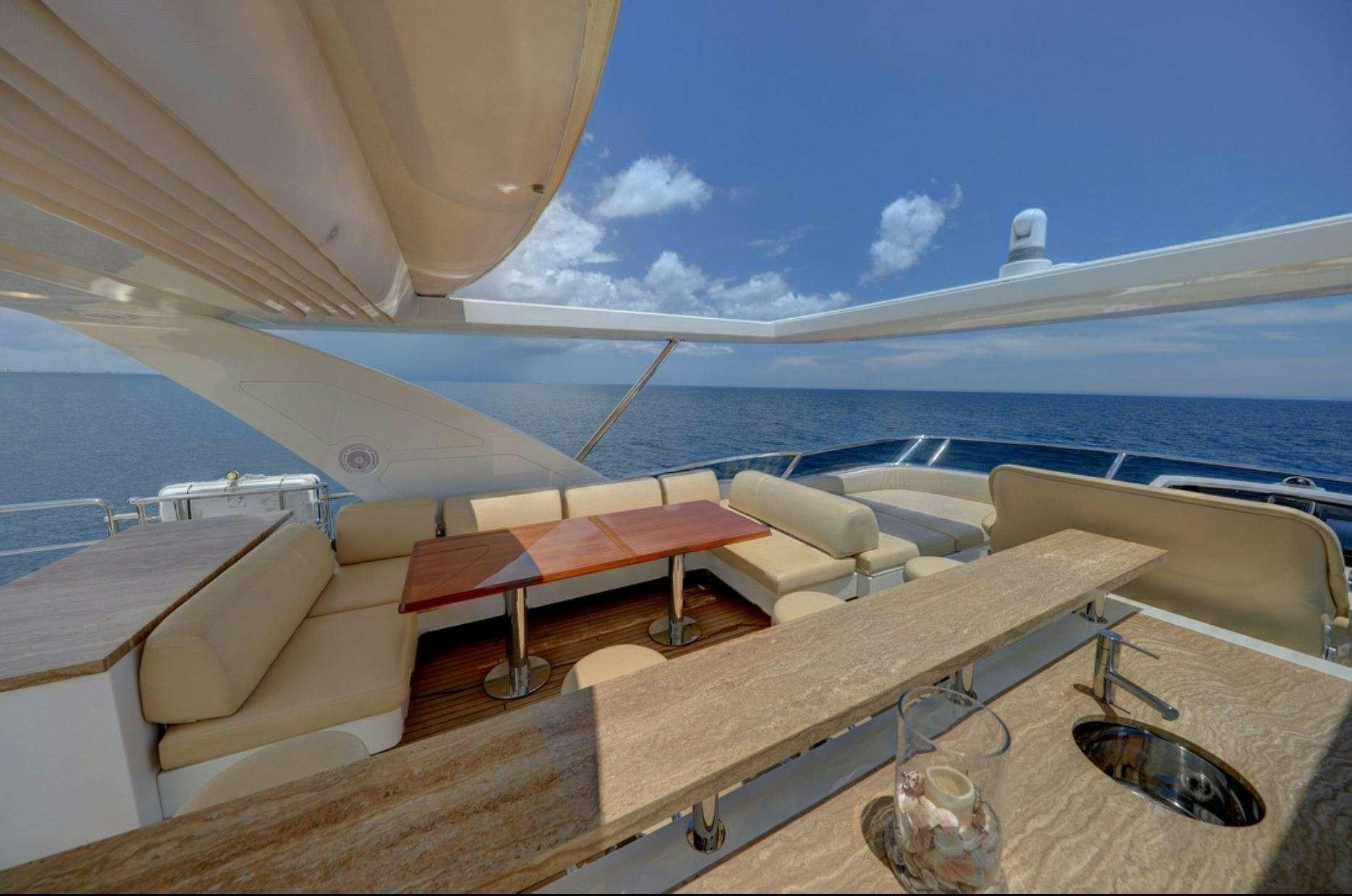 a deck with a pool and a boat in the water aboard VALERE Yacht for Charter