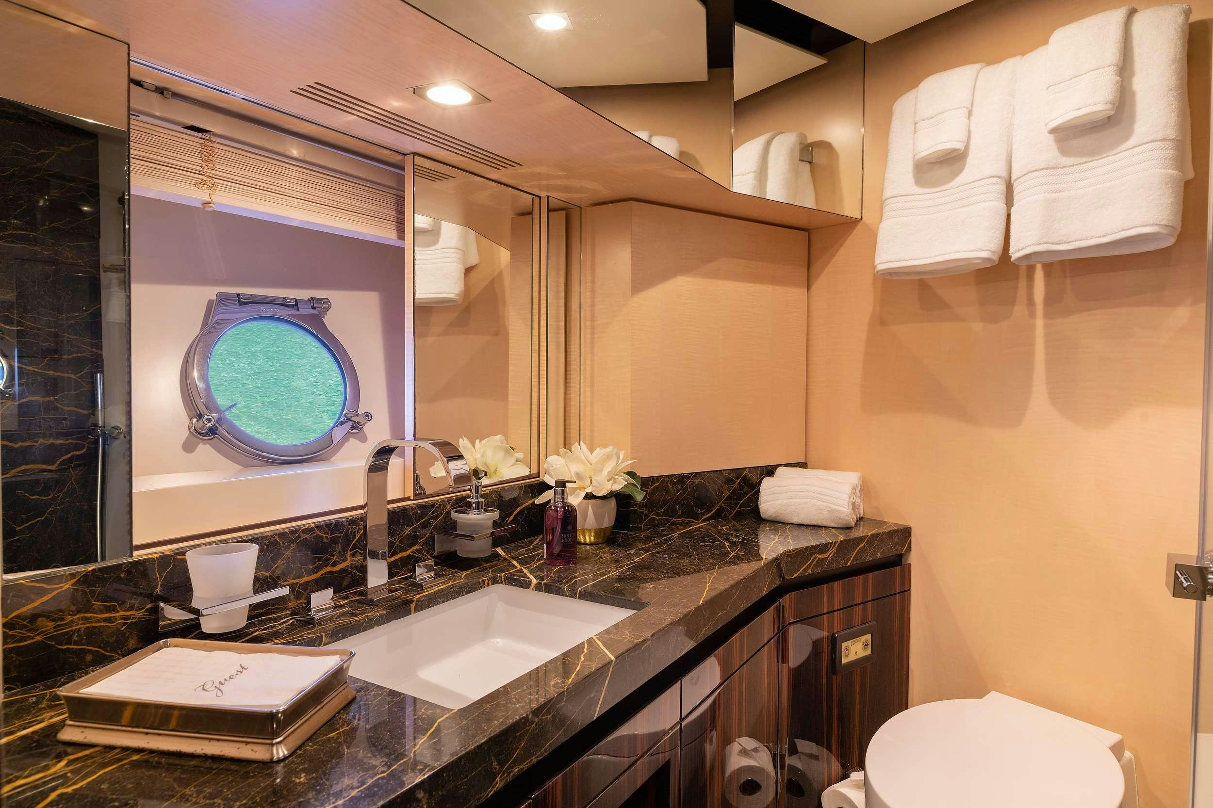 a bathroom with a large mirror aboard VALERE Yacht for Charter