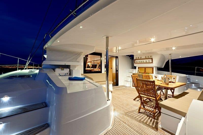 a room with a table and chairs aboard LUXURY TW60 5 CABIN Yacht for Charter