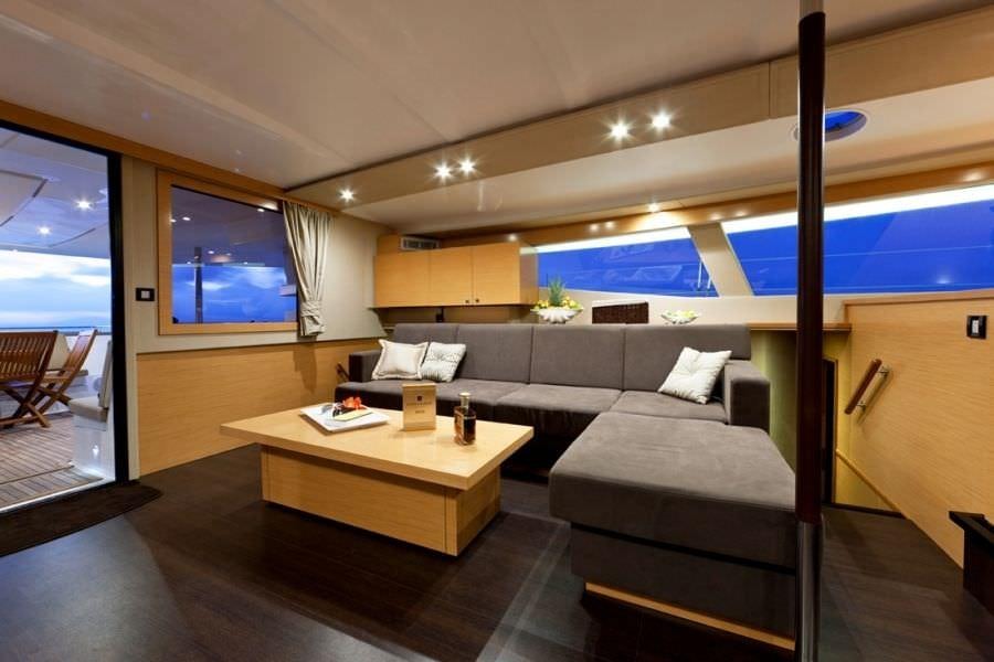 a living room with a couch and a table aboard LUXURY TW60 5 CABIN Yacht for Charter