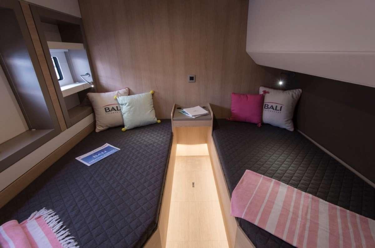 a room with a bed and a desk aboard Crystal Dreams Yacht for Charter