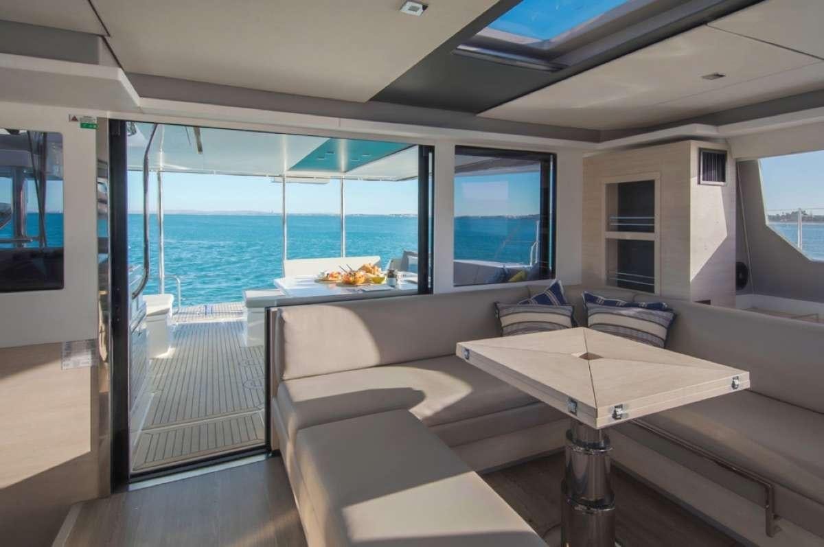 a room with a table and chairs aboard Atumavu Yacht for Charter