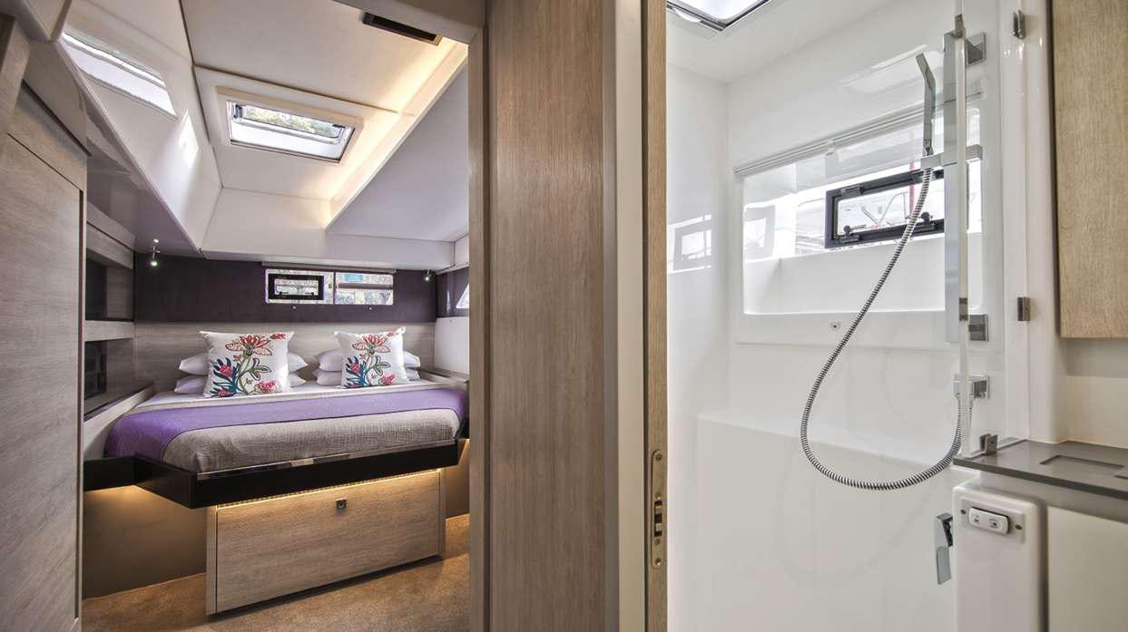 a room with a bed and a desk aboard Atumavu Yacht for Charter