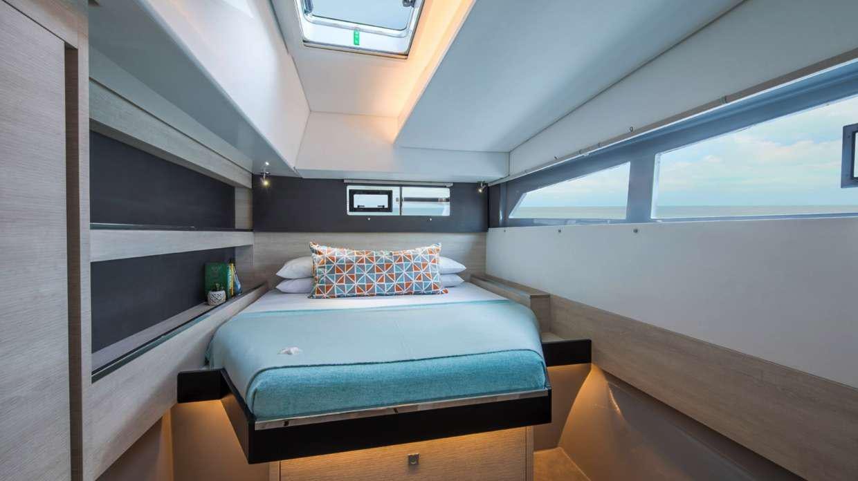 a room with a bed and a window aboard Atumavu Yacht for Charter