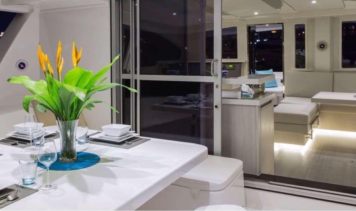 a vase of yellow flowers on a table aboard JamSam Yacht for Charter