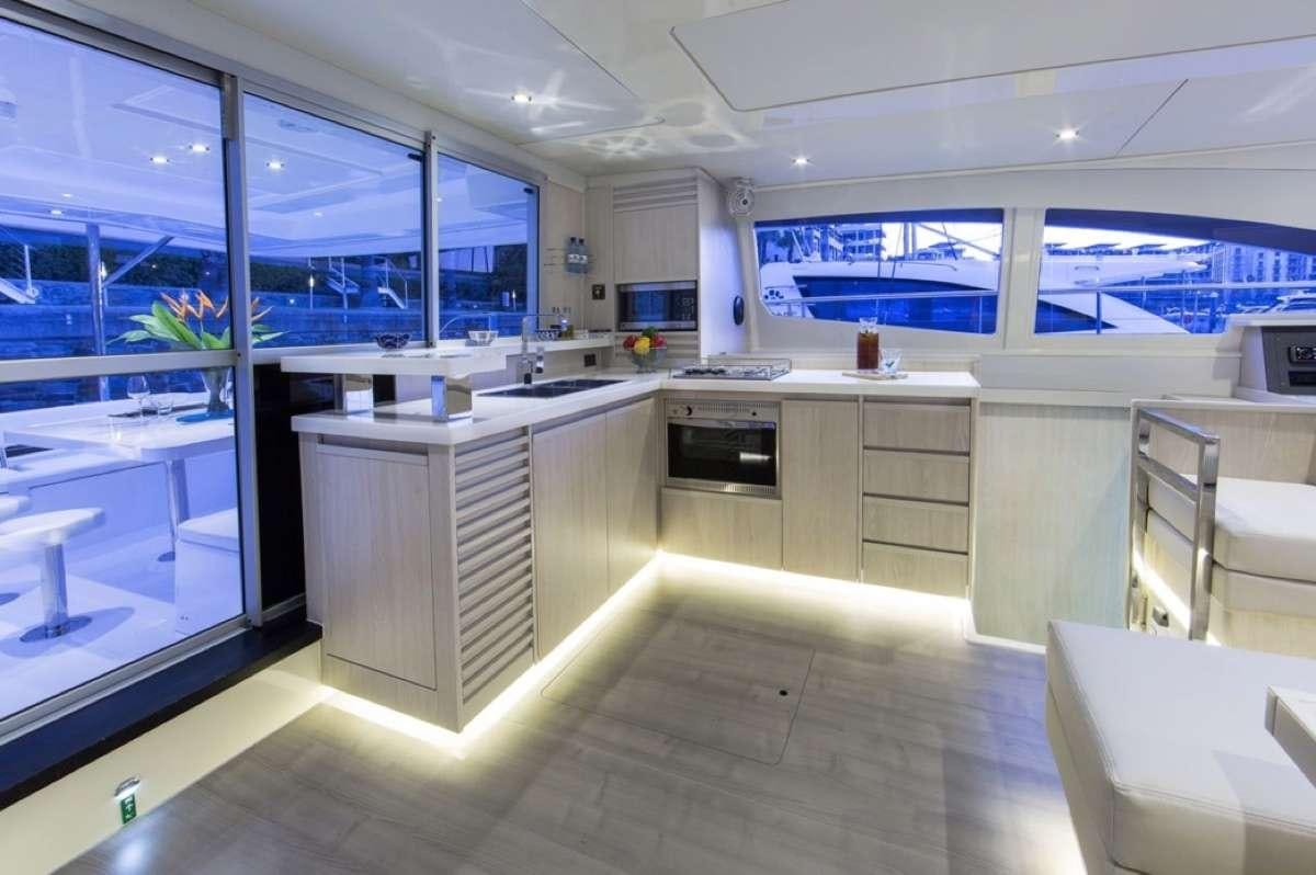 a kitchen with a large window aboard JamSam Yacht for Charter