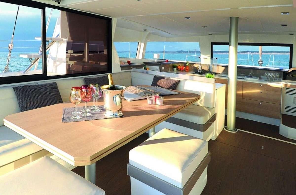 a table with glasses and a vase on it aboard Barbara Jane Yacht for Charter