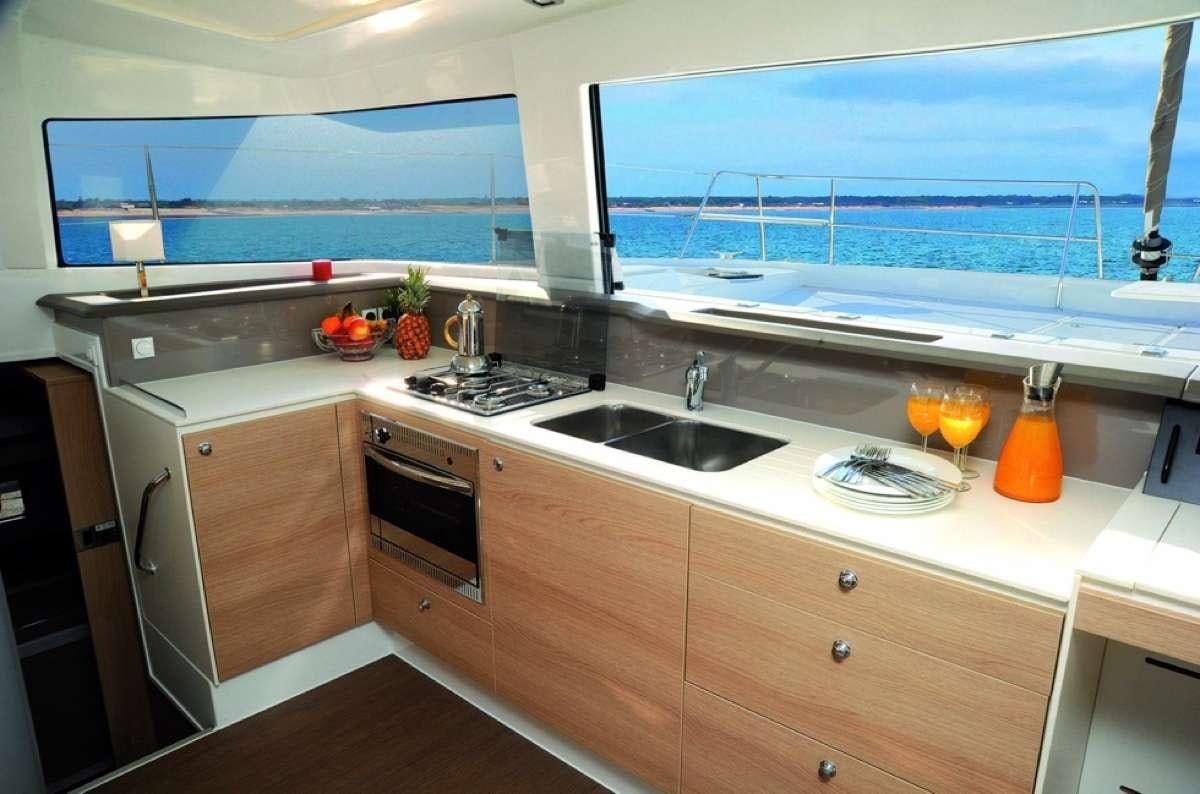a kitchen with a glass of wine aboard Barbara Jane Yacht for Charter