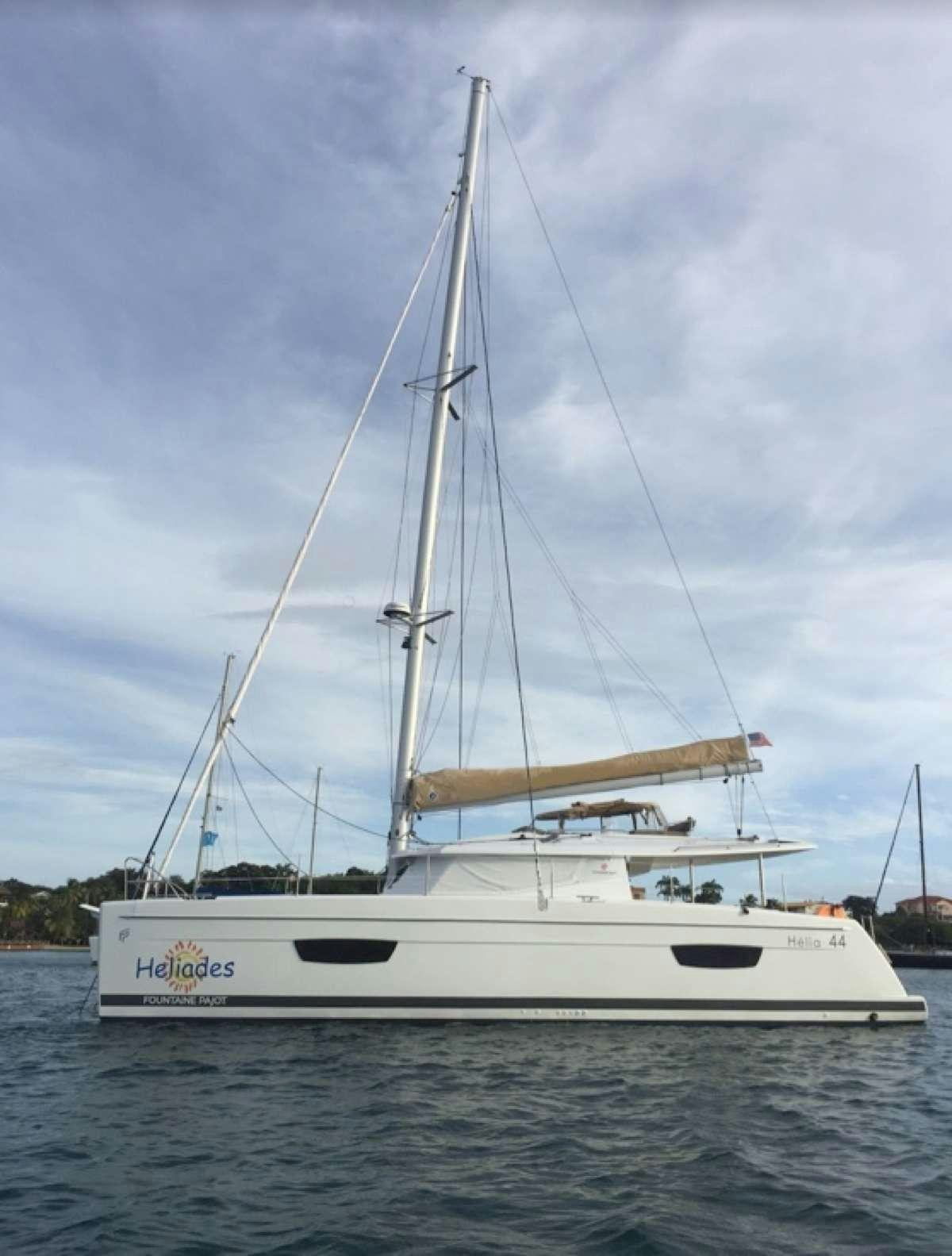a white boat on the water aboard Heliades Yacht for Charter
