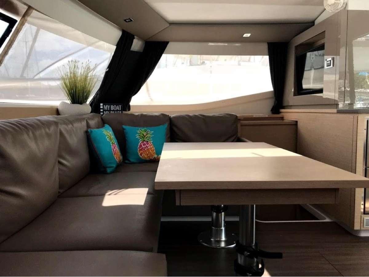 a living room with a couch and a coffee table aboard Heliades Yacht for Charter