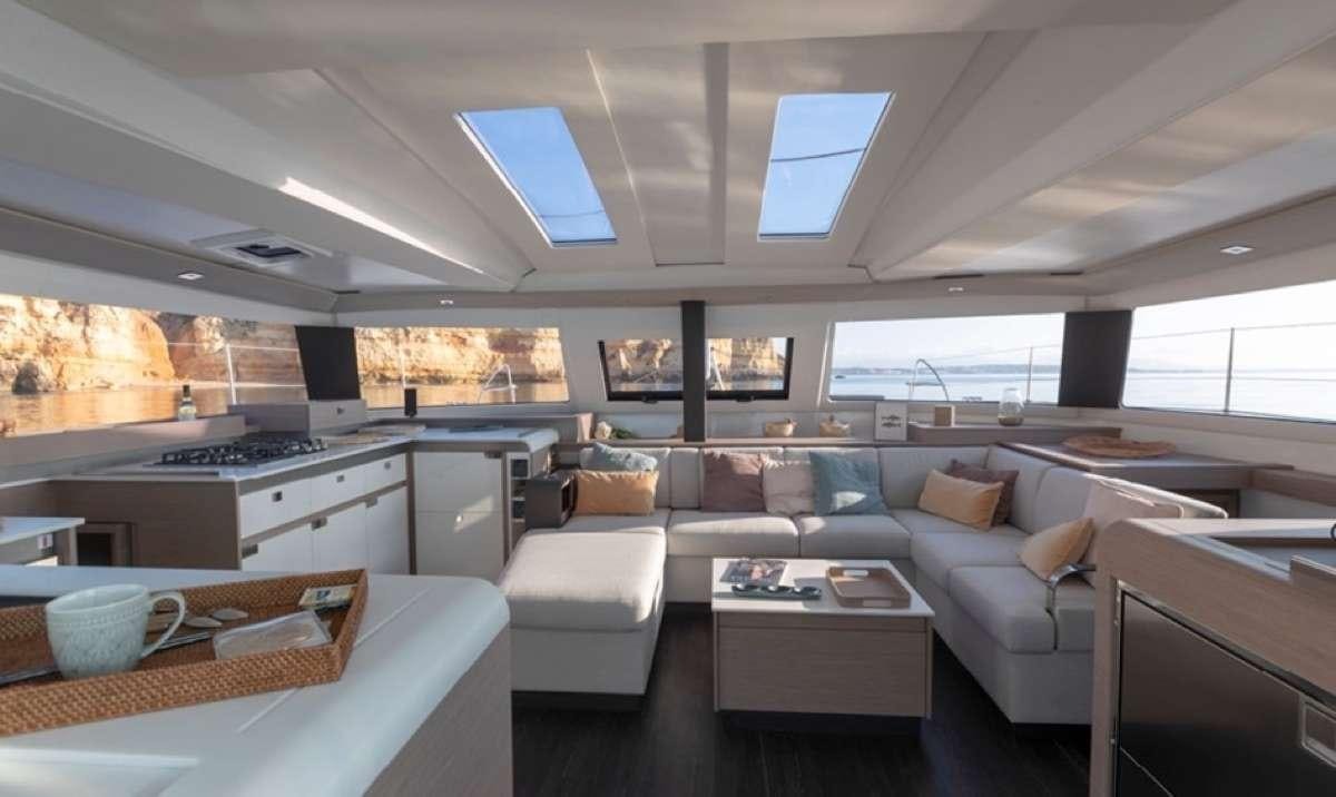 a large living room with a large window aboard Game Changer Yacht for Charter