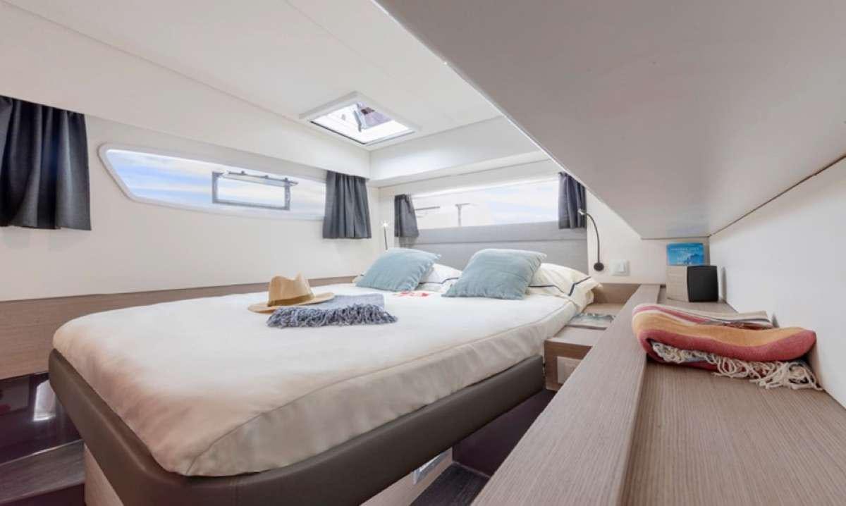 a room with two beds aboard Game Changer Yacht for Charter