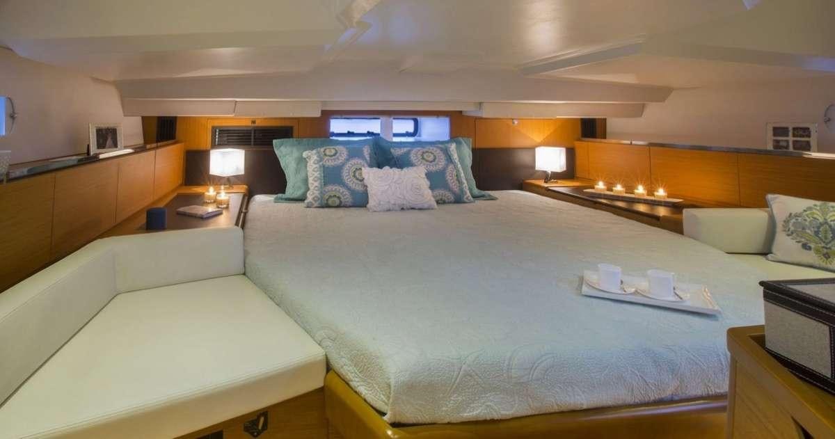a hotel room with a bed and a television aboard Sea Wolf Yacht for Charter