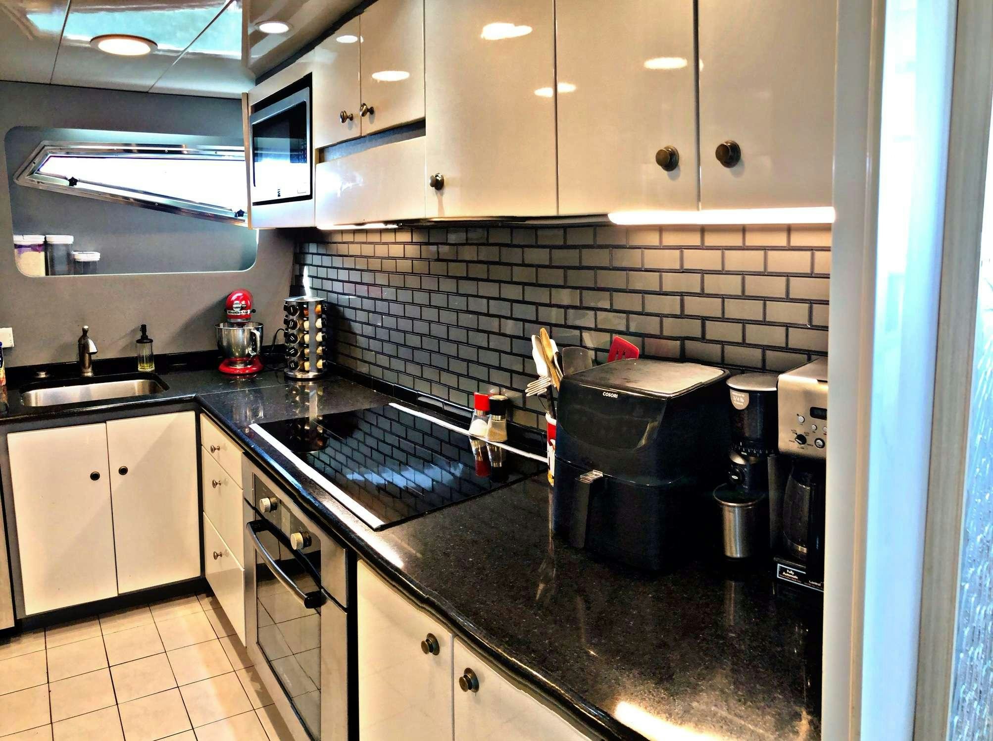a kitchen with white cabinets aboard RUNAWAY OF TORTOLA Yacht for Charter
