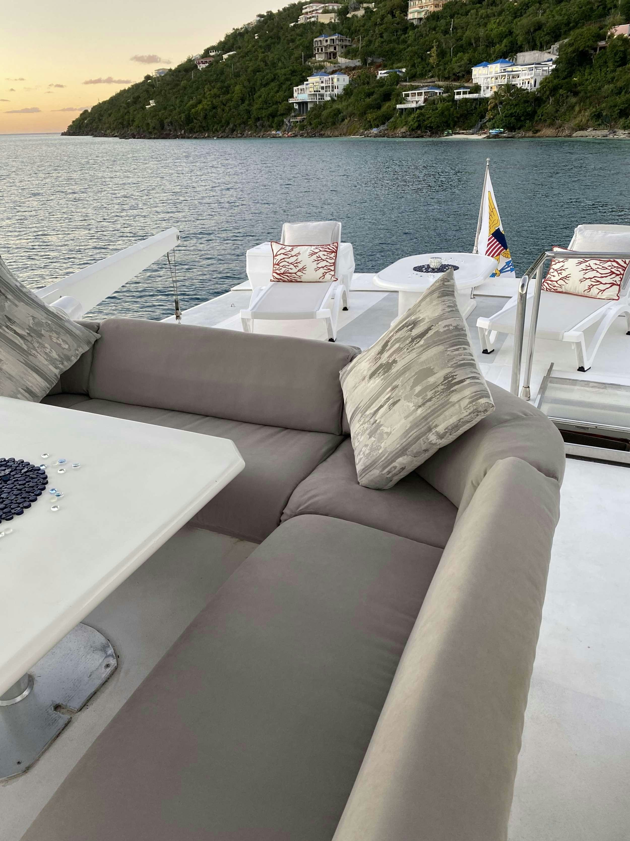 a couch with pillows on it by the water aboard RUNAWAY OF TORTOLA Yacht for Charter