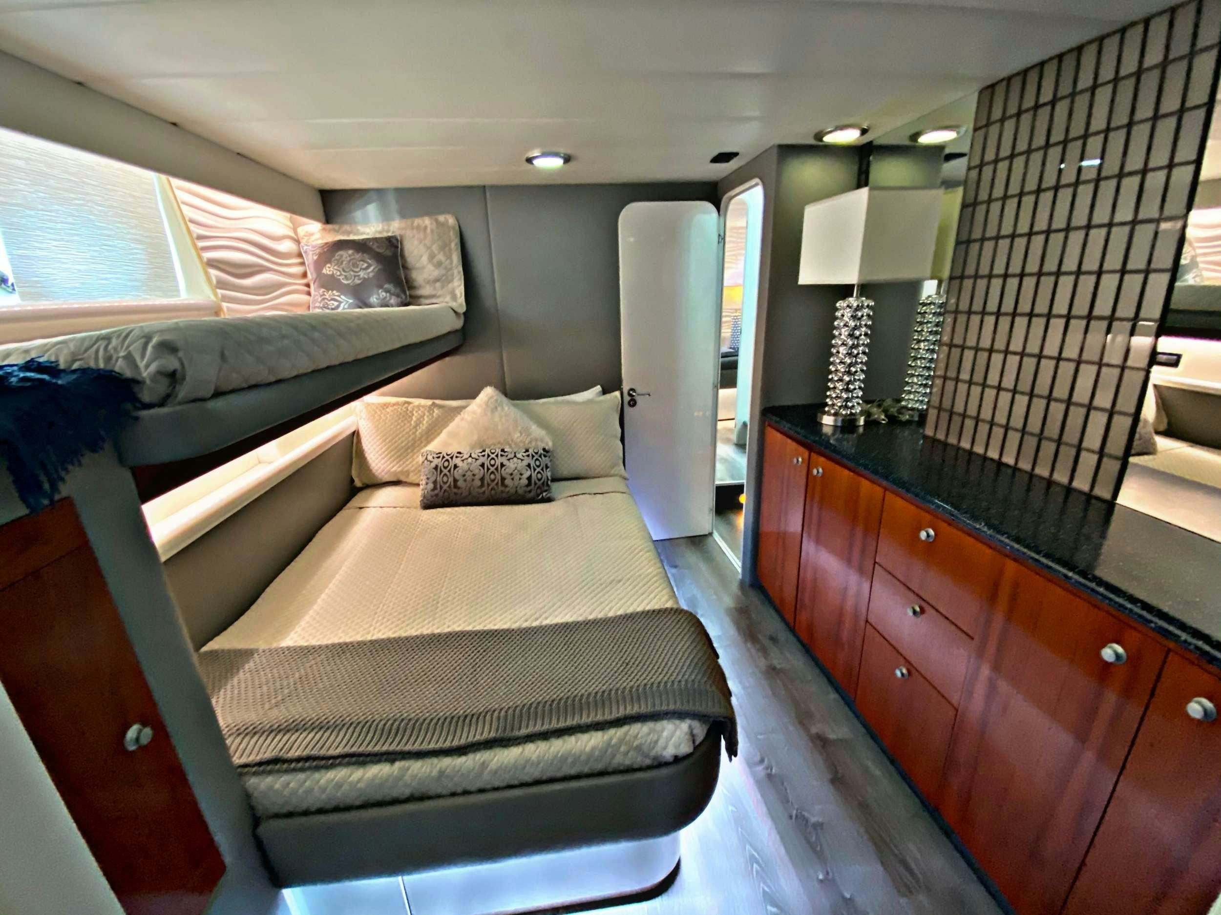 a bedroom with a bed and a dresser aboard RUNAWAY OF TORTOLA Yacht for Charter