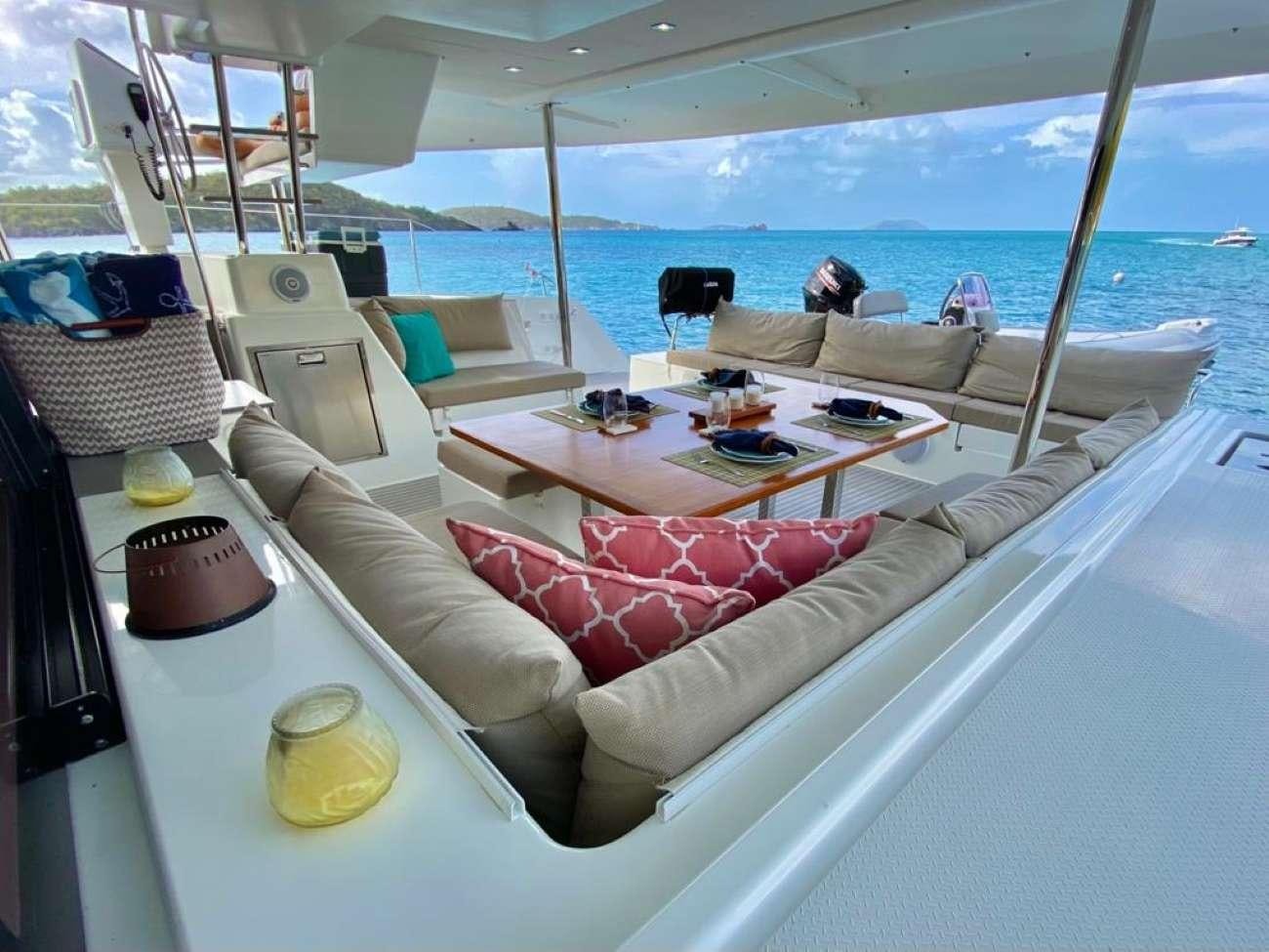 a boat with a table and chairs aboard OCEANFRONT PROPERTY Yacht for Charter