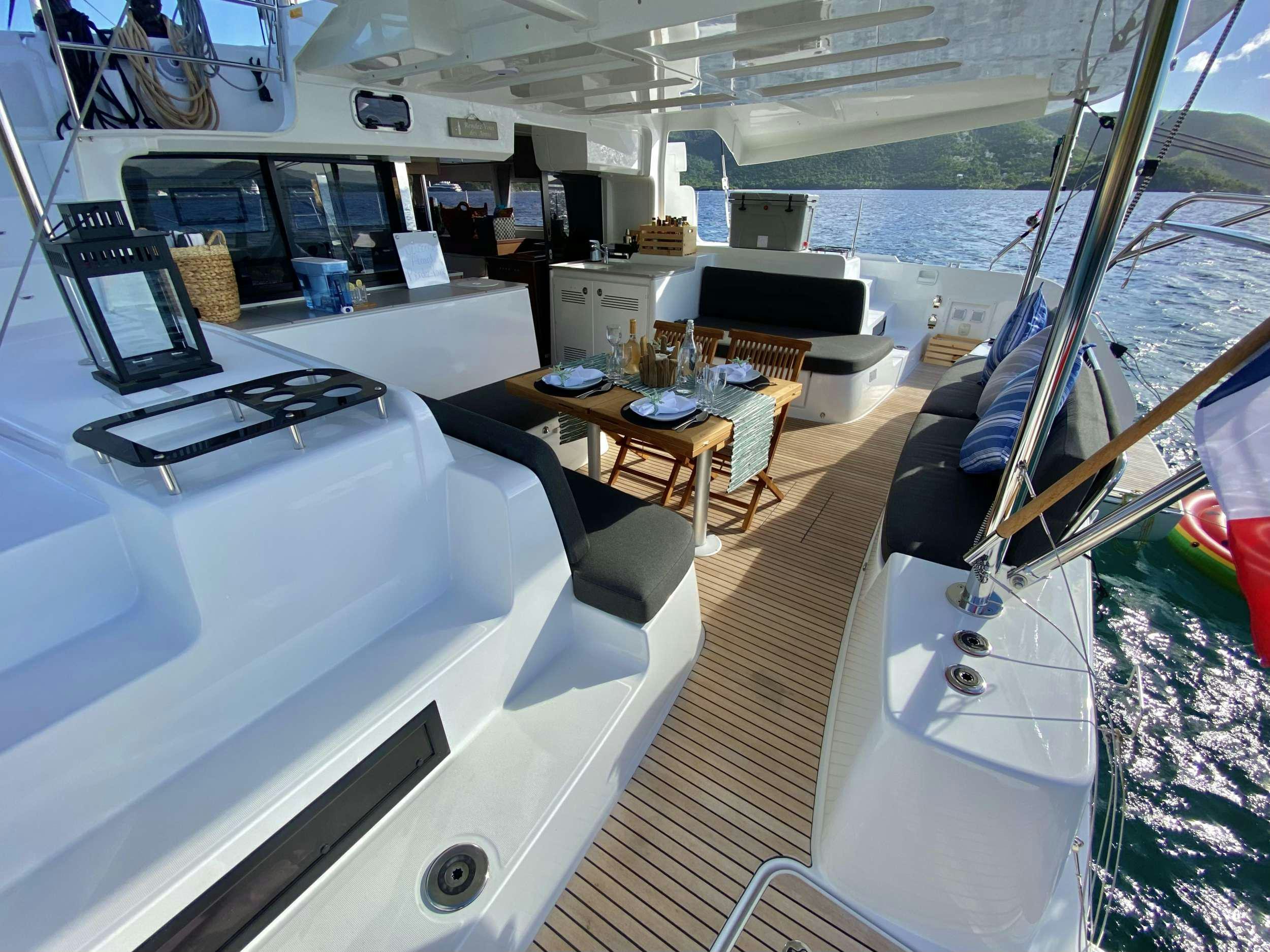 a boat with a bed and a table aboard RENDEZ-VOUS Yacht for Charter