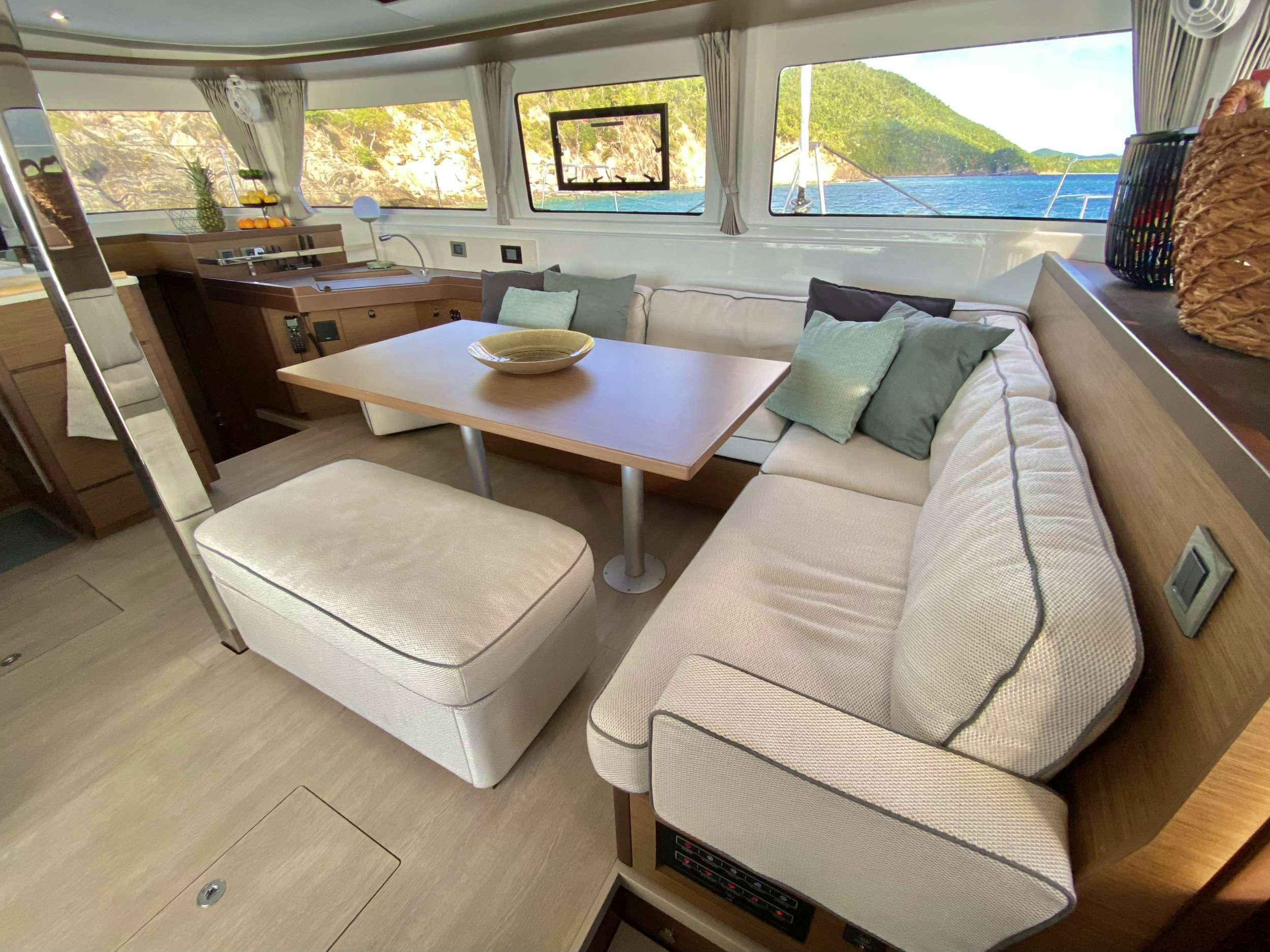 a living room with a couch and a table aboard RENDEZ-VOUS Yacht for Charter