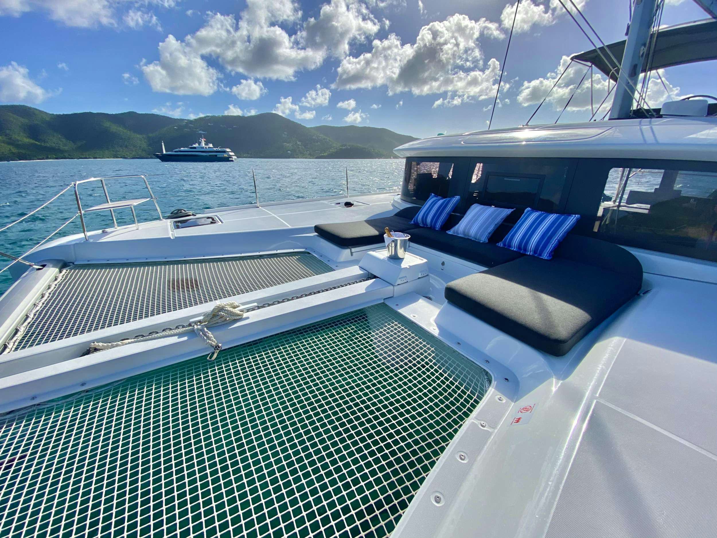 a deck with a pool and boats on it aboard RENDEZ-VOUS Yacht for Charter