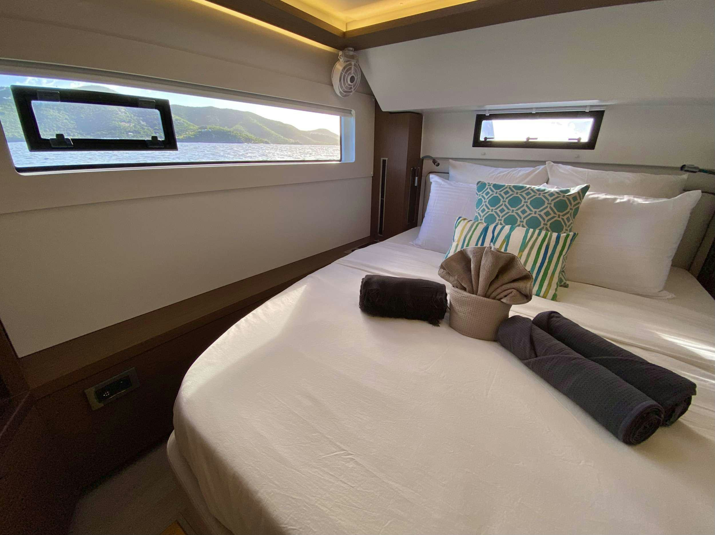 a bed with pillows and pillows aboard RENDEZ-VOUS Yacht for Charter