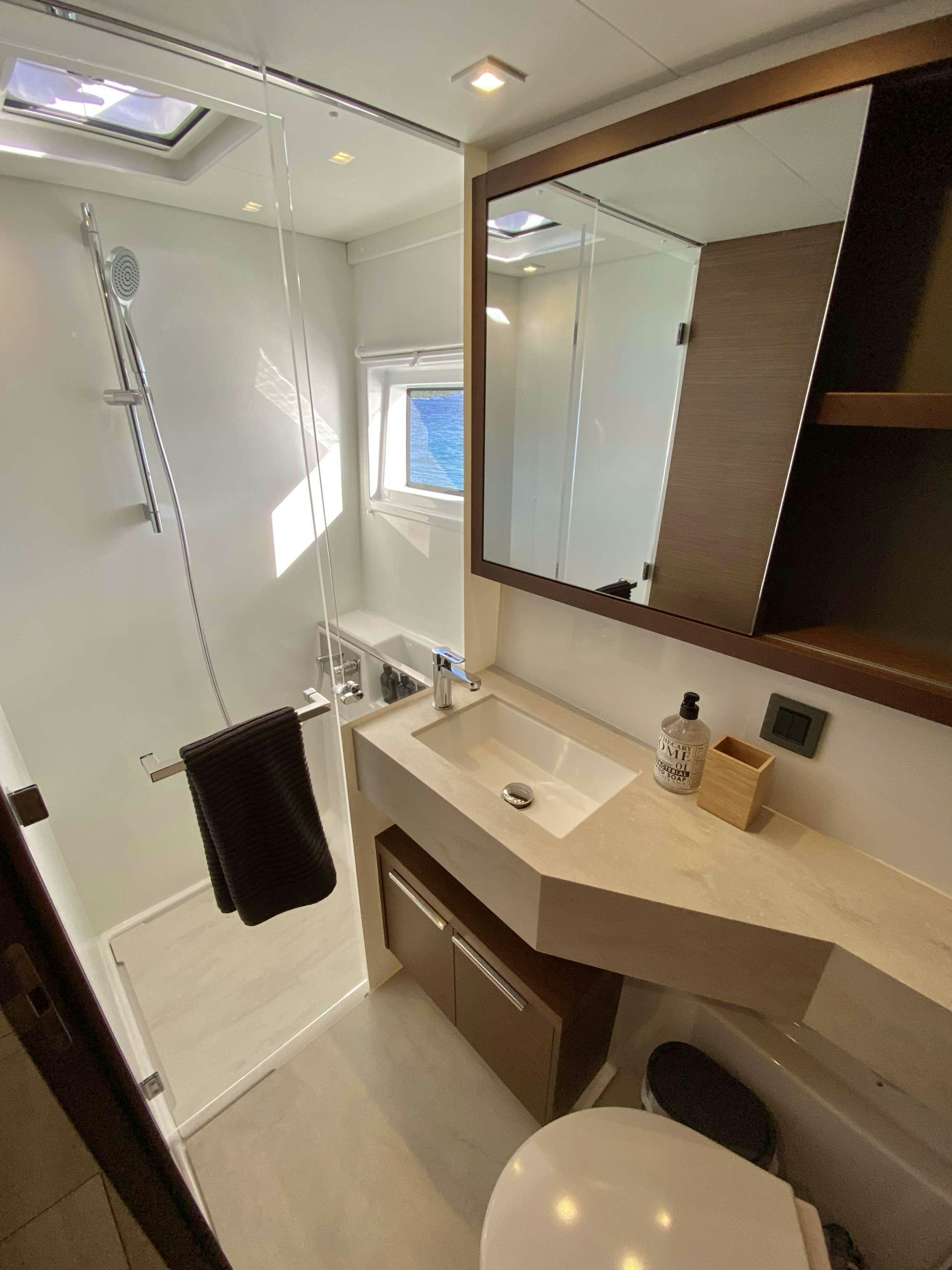 a bathroom with a large mirror aboard RENDEZ-VOUS Yacht for Charter