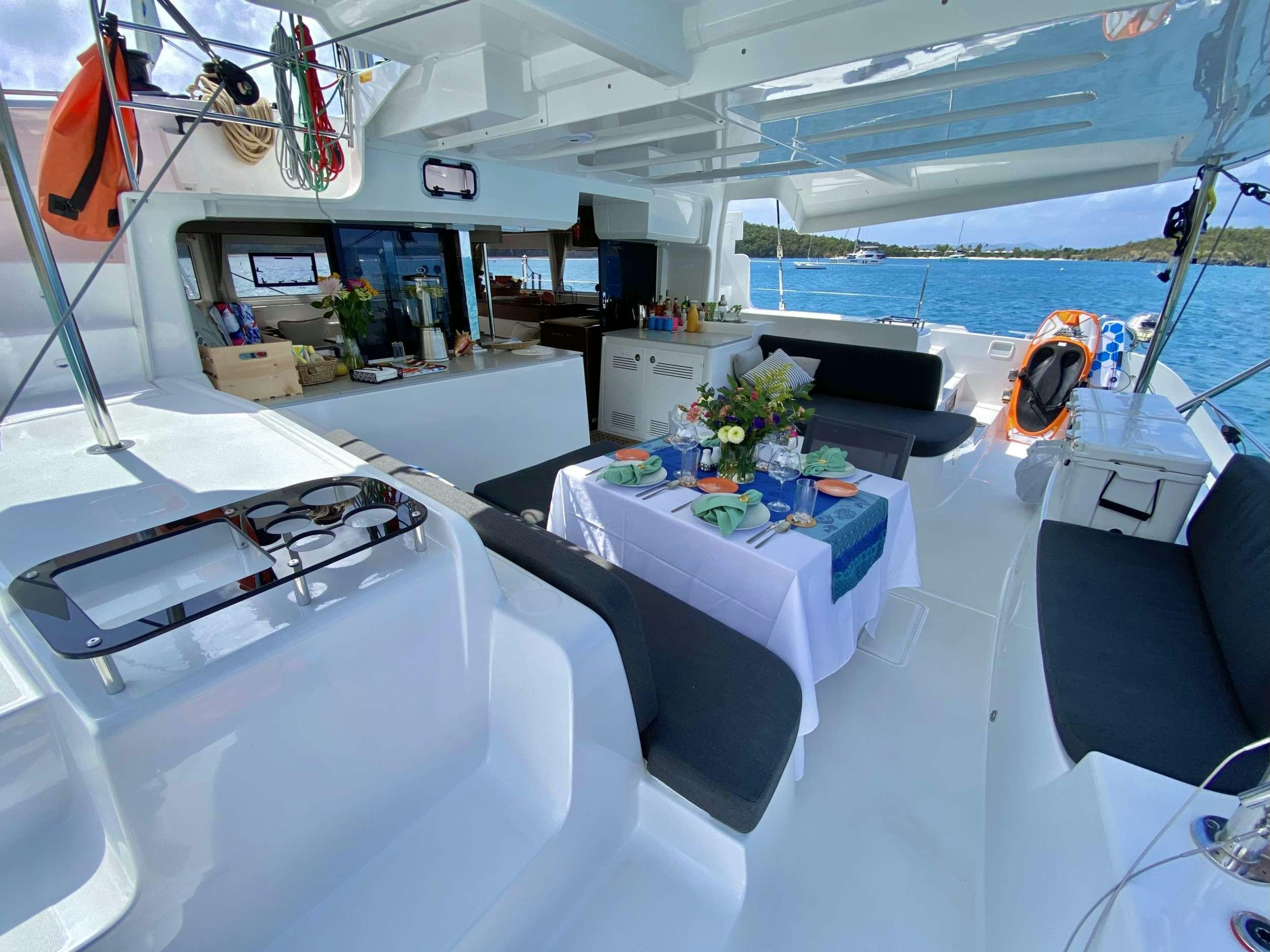 a large white room with a table and chairs and a boat aboard EASIR II Yacht for Charter