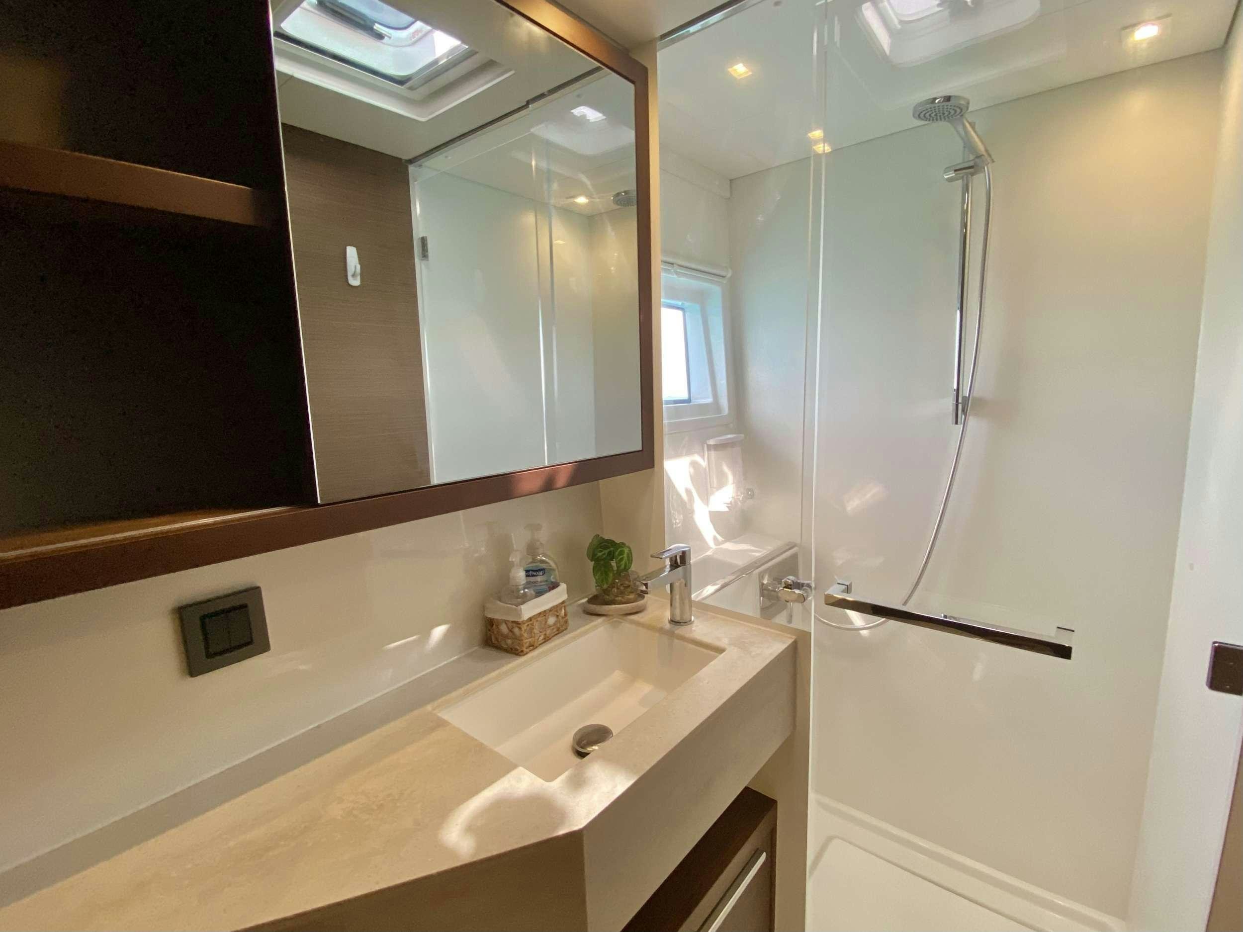 a bathroom with a shower unit and sink aboard EASIR II Yacht for Charter