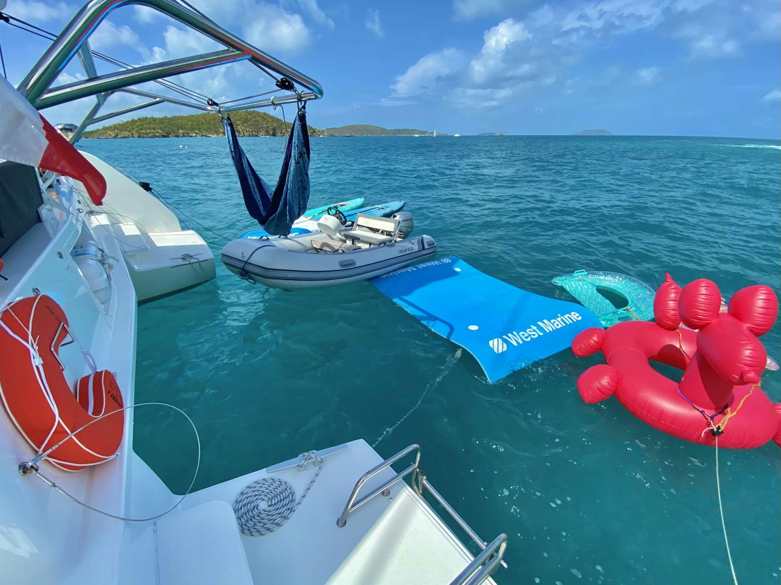 a boat with a book and a red balloon on the front aboard EASIR II Yacht for Charter