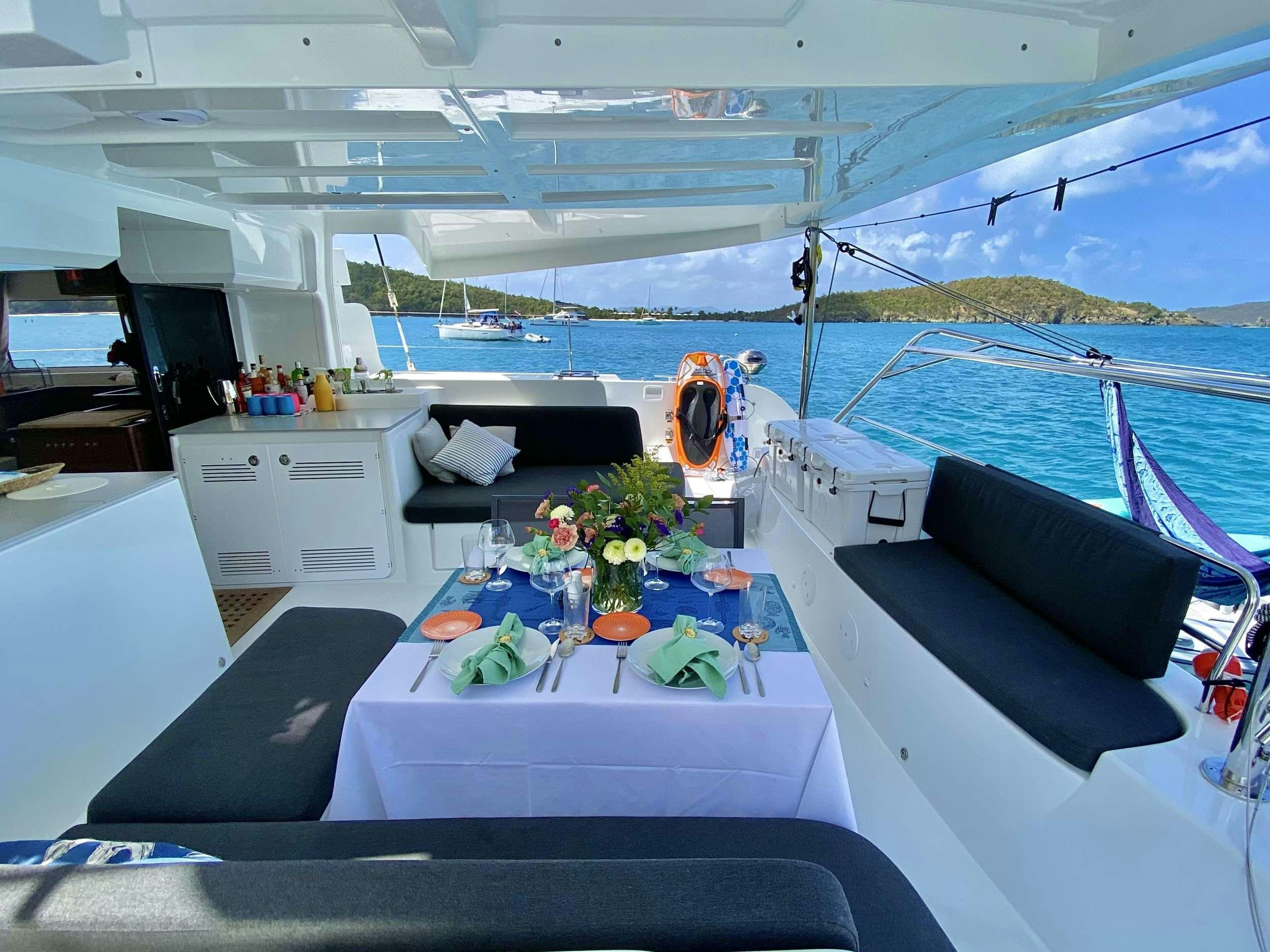 a boat with a table and chairs aboard EASIR II Yacht for Charter