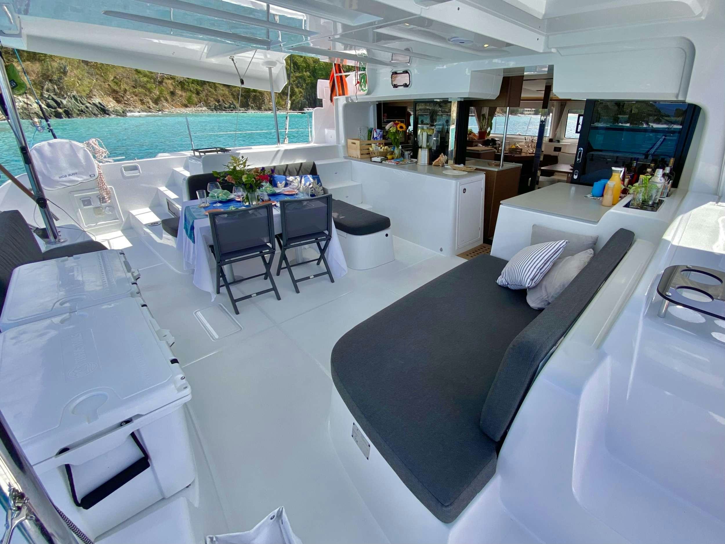 a large room with a table and chairs aboard EASIR II Yacht for Charter