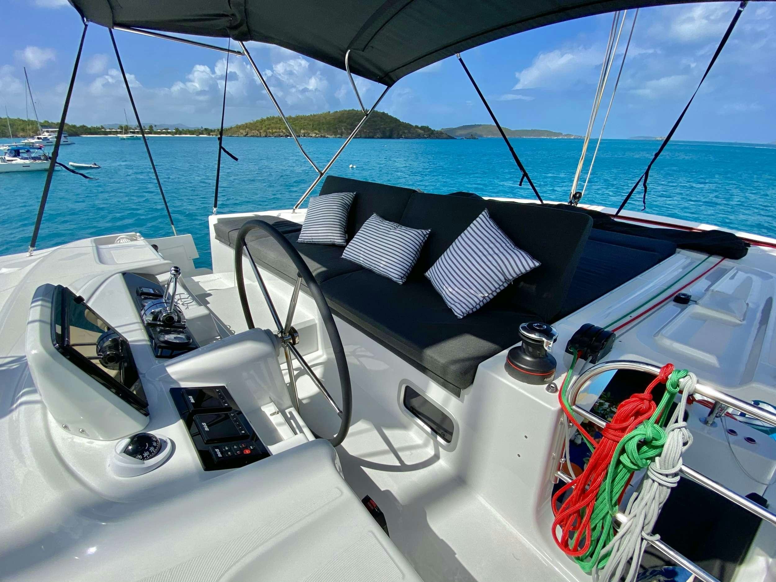 a boat with a deck and a chair on it aboard EASIR II Yacht for Charter