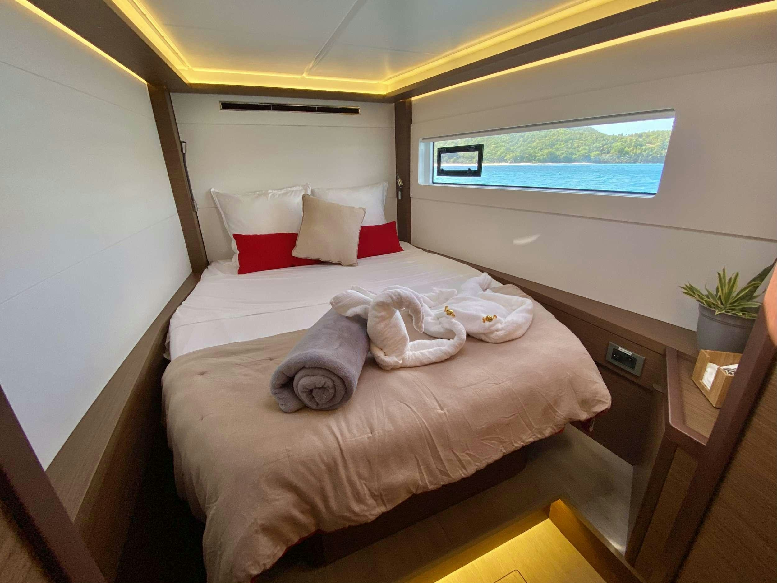 a bed with pillows and pillows aboard EASIR II Yacht for Charter