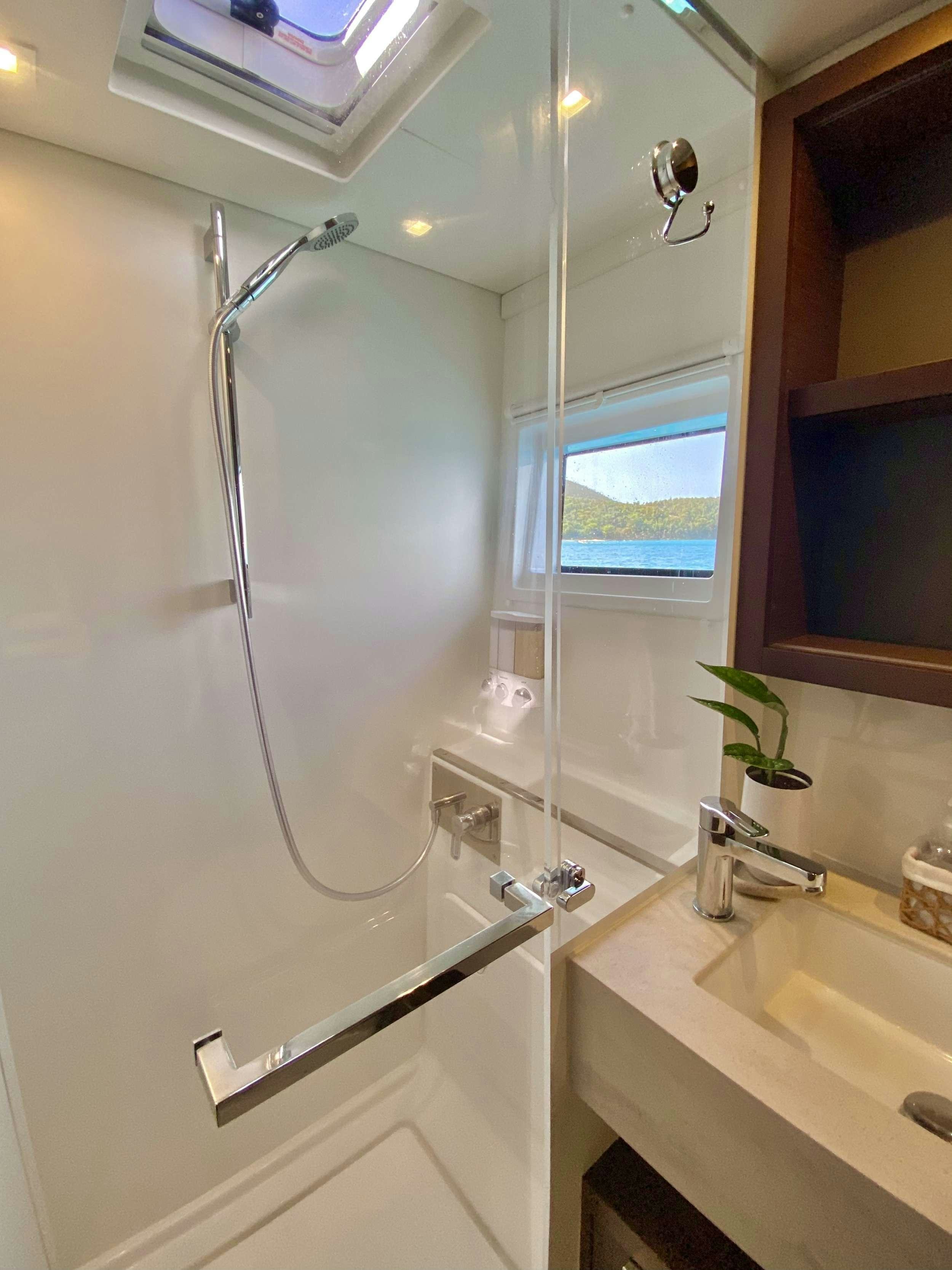 a shower unit in a bathroom aboard EASIR II Yacht for Charter