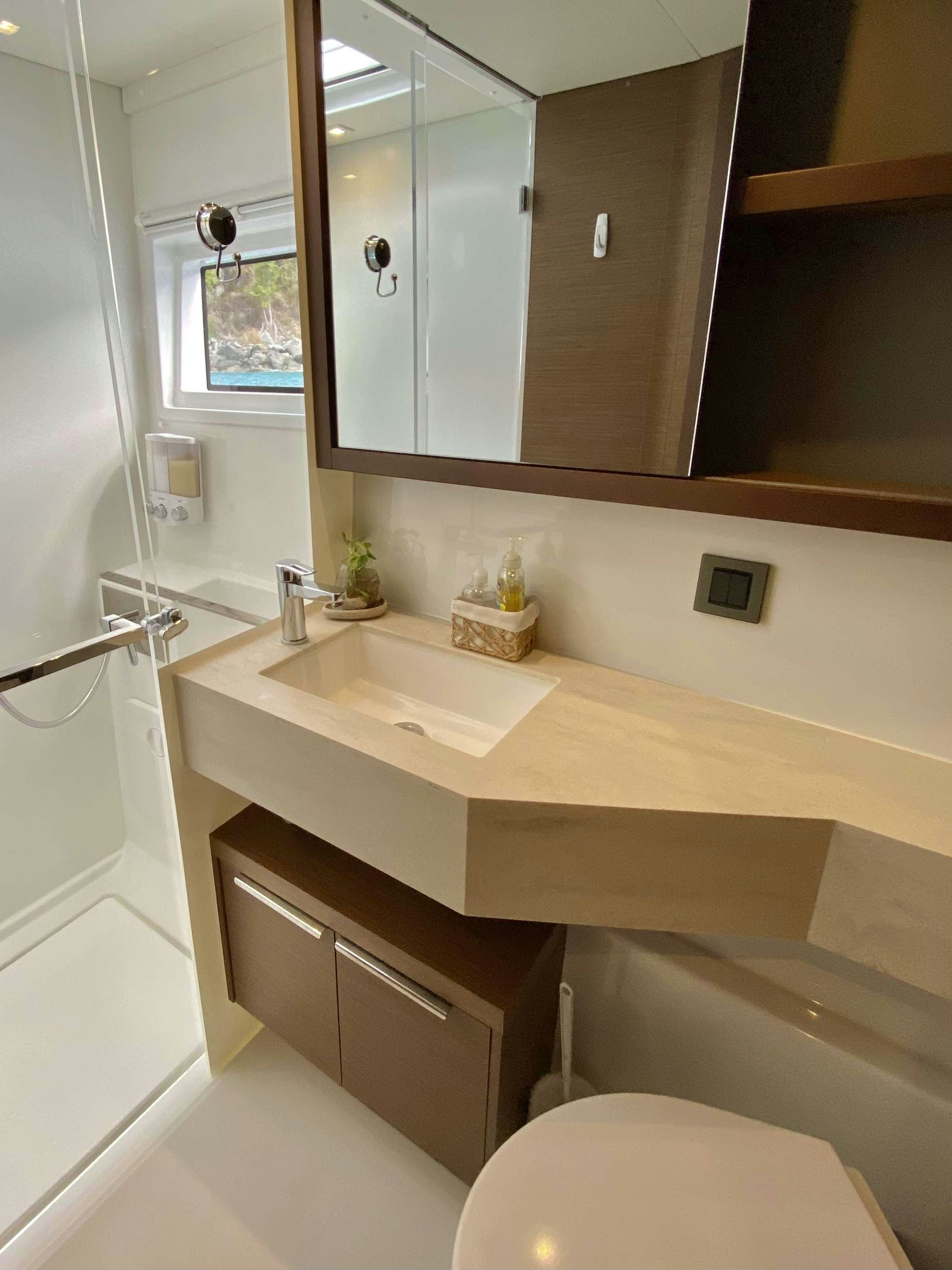 a bathroom with a sink and a mirror aboard EASIR II Yacht for Charter
