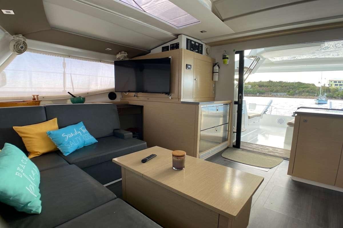 a living room with a couch and a table aboard IREMIA Yacht for Charter