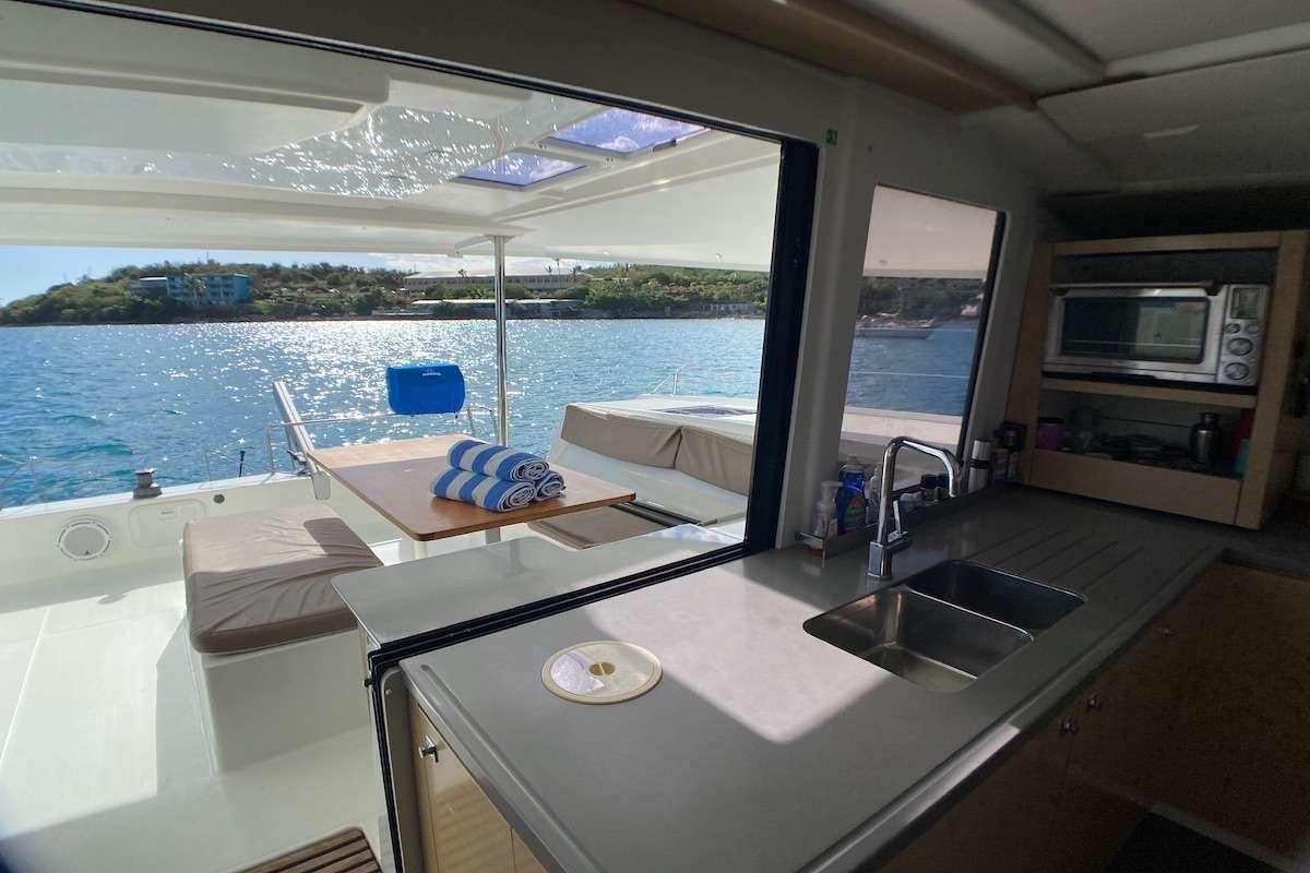 a kitchen with a sink and microwave aboard IREMIA Yacht for Charter