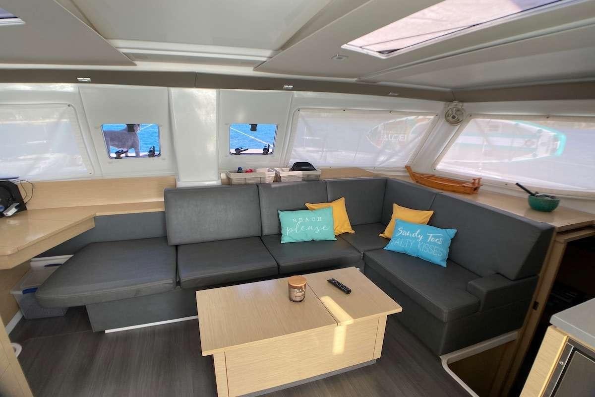 a room with a couch and a table aboard IREMIA Yacht for Charter