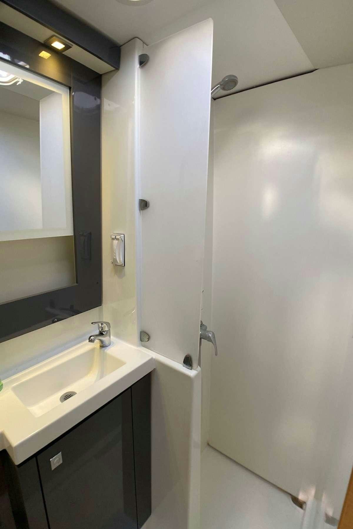 a bathroom with a sink and a mirror aboard IREMIA Yacht for Charter