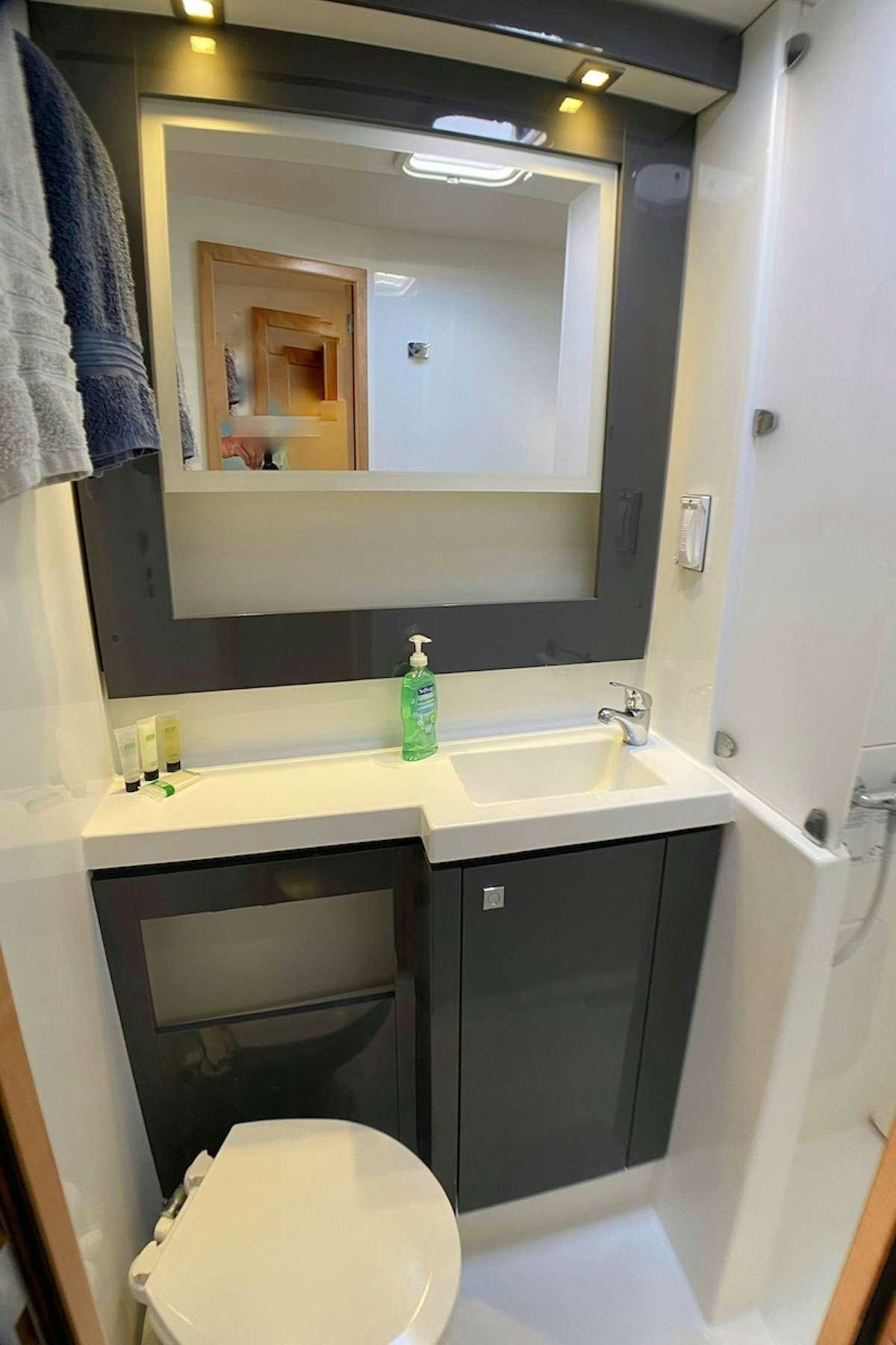 a bathroom with a toilet and a sink aboard IREMIA Yacht for Charter